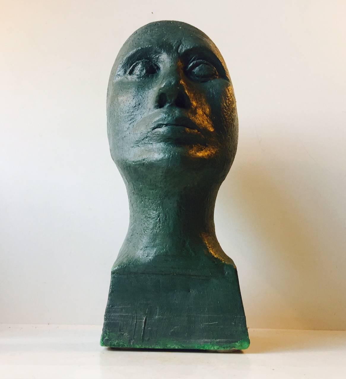 Monumental concrete bust with a verdigris green finish. Everything about is anonymous. However it displays a sudden mount of contemporary artistic quality and would serve as an ice-breaker to any minimalistic interior. The flat surfaces to the sides