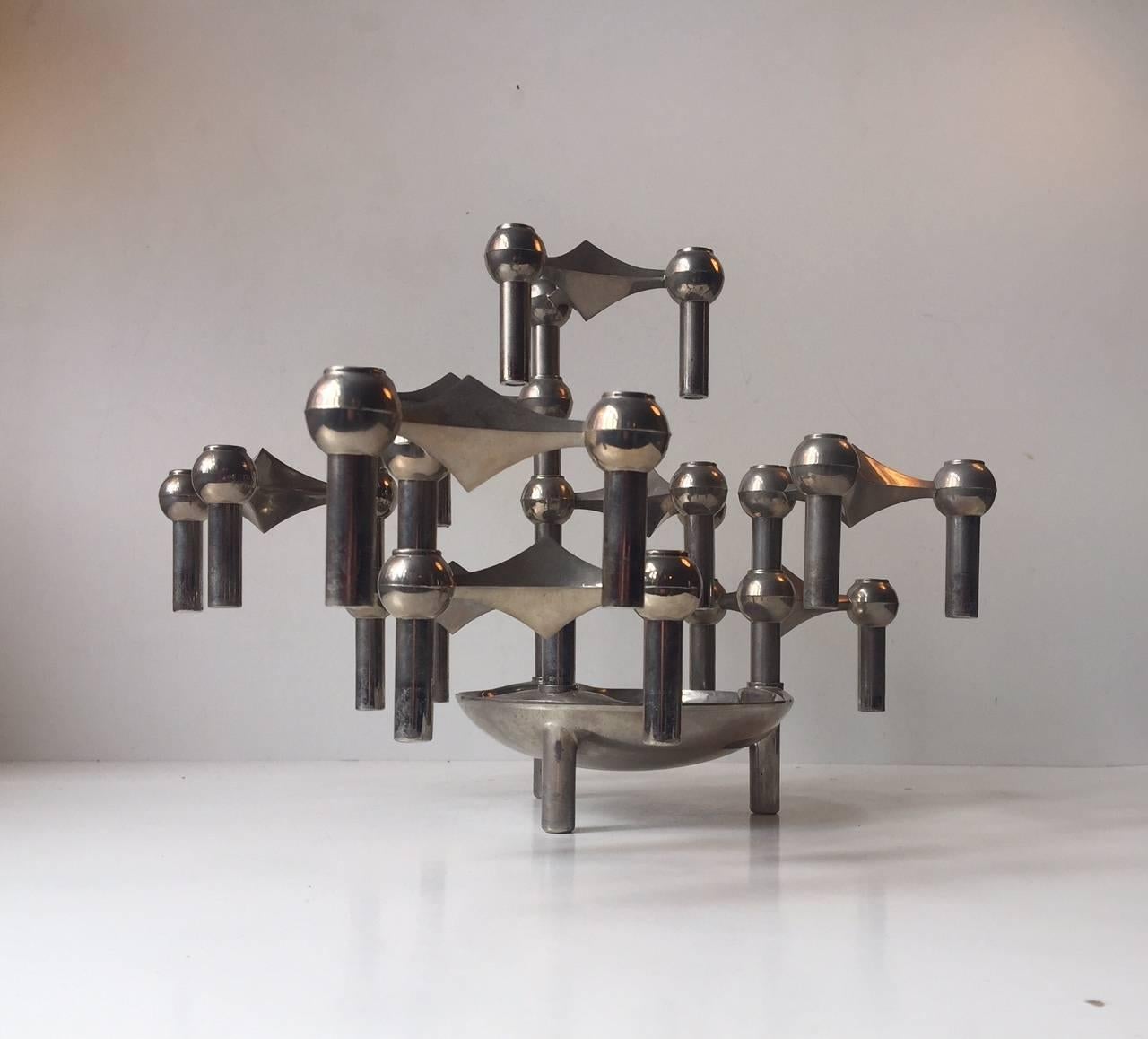 A molecular/atomic looking sculpture made of nine individual candleholders and a bowl or base. The system is designed by Caesar Stoffi and Fritz Nagel for BMF in Germany during the 1960s. This modular design can be configured in an endless number of