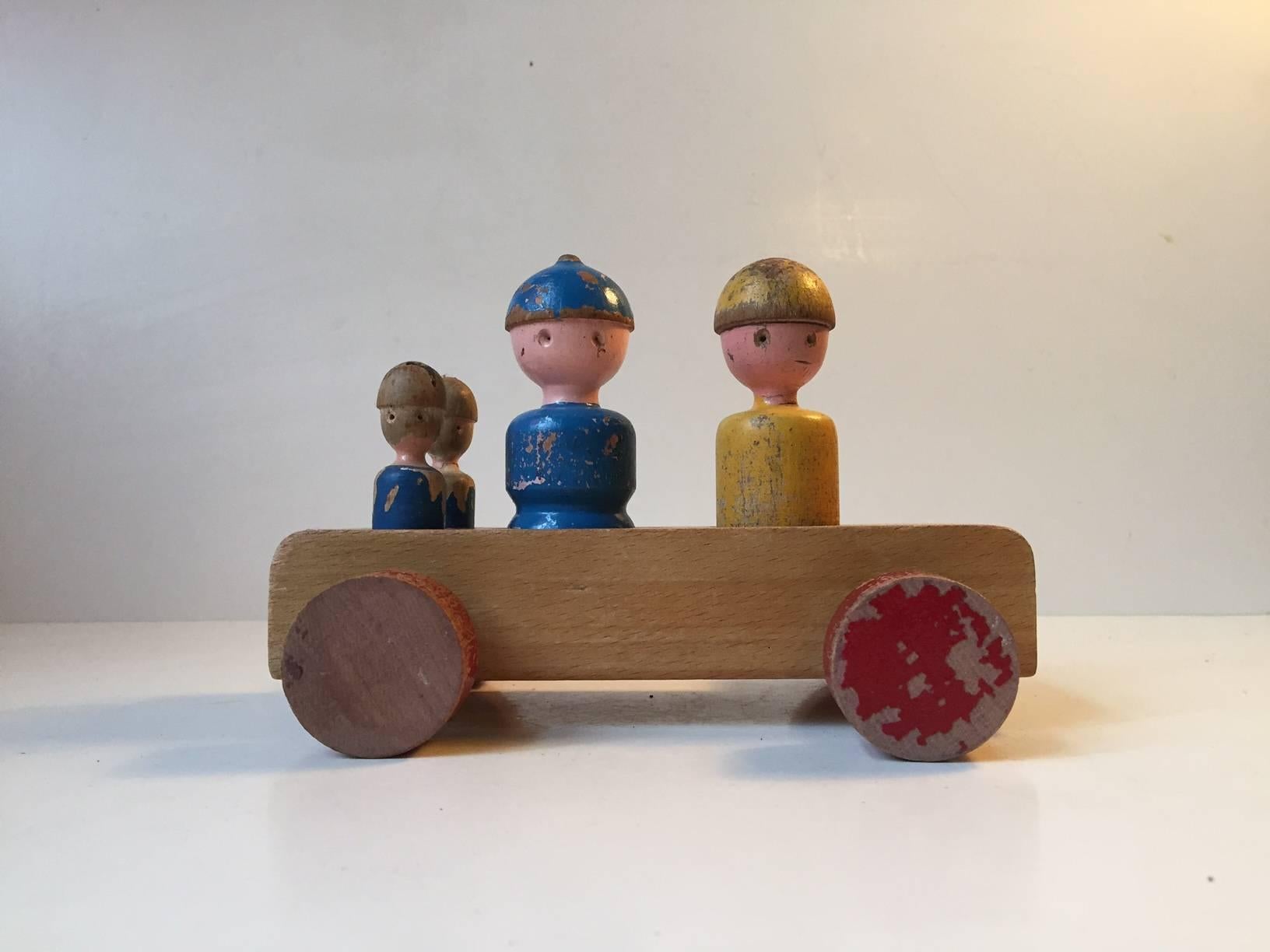 This Wagon designed by Kay Bojesen in the 1950s features four characters in a wagon: mother, father and their two sons. This items has been loved and played with for many years and this shows in the most charming and 'chappy' way.
