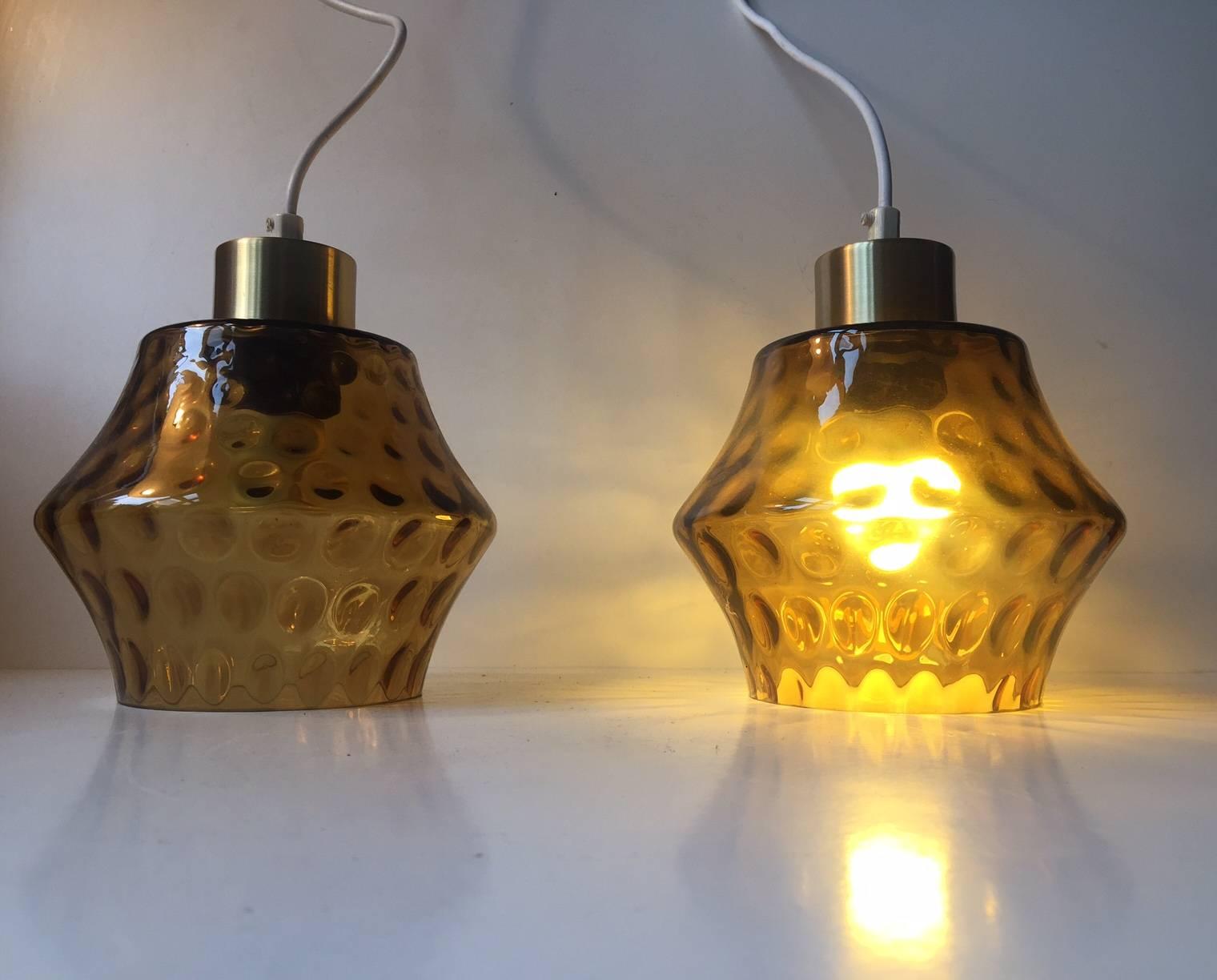 A pair of smoke glass pendants with optical dots. Manufactured and designed by Vitrika in Denmark during the 1960s. Each are fitted with 2 meters white textile wire. The price is for the pair.