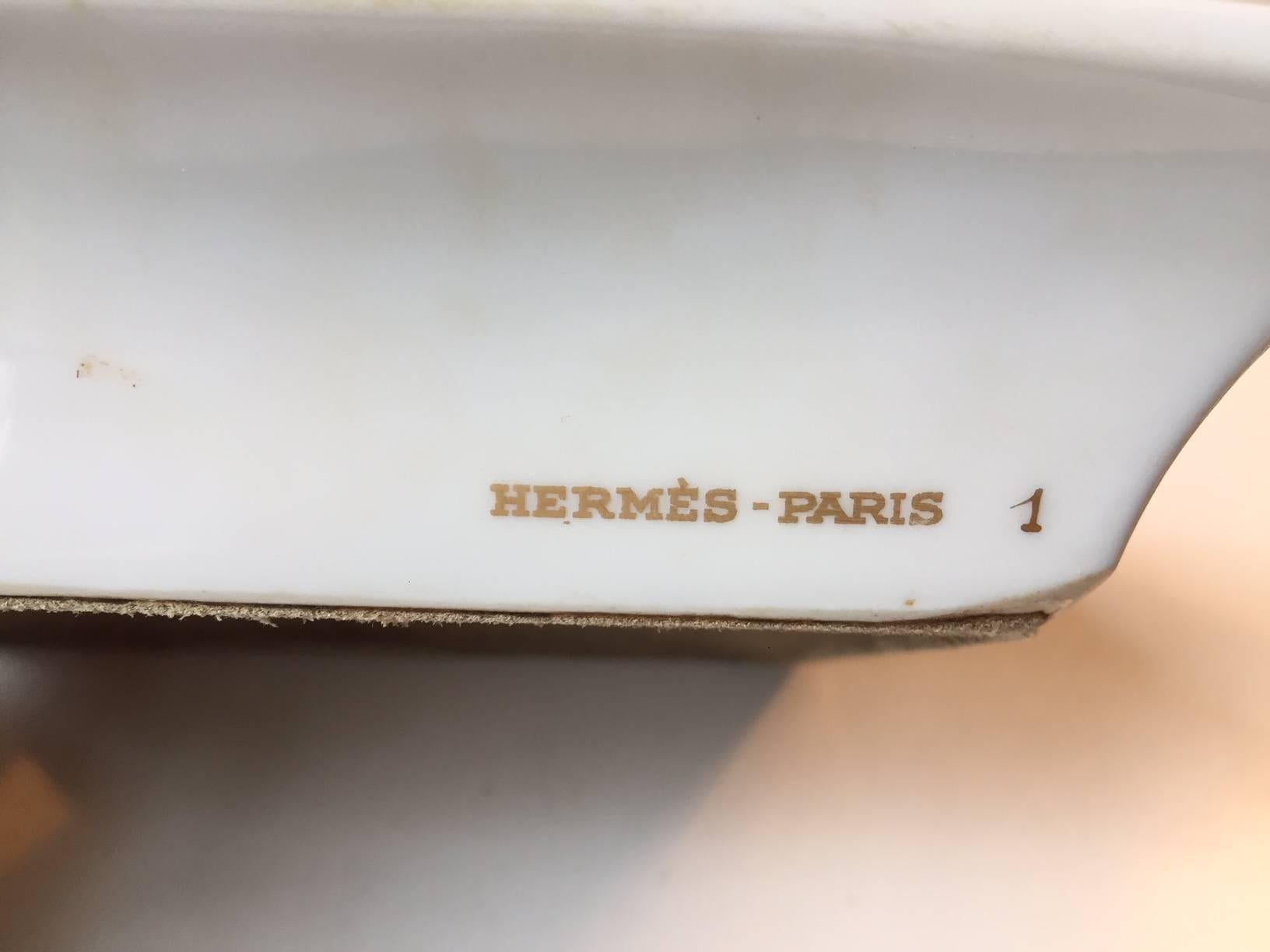 Hermes porcelain cigar ashtray manufactured and designed in the 1980s. Rectangular porcelain body with polychrome decoration of Cattails/Typha’s to the edge and a hand-painted Duck Motif to the middle. It is marked HERMES PARIS one to one side and