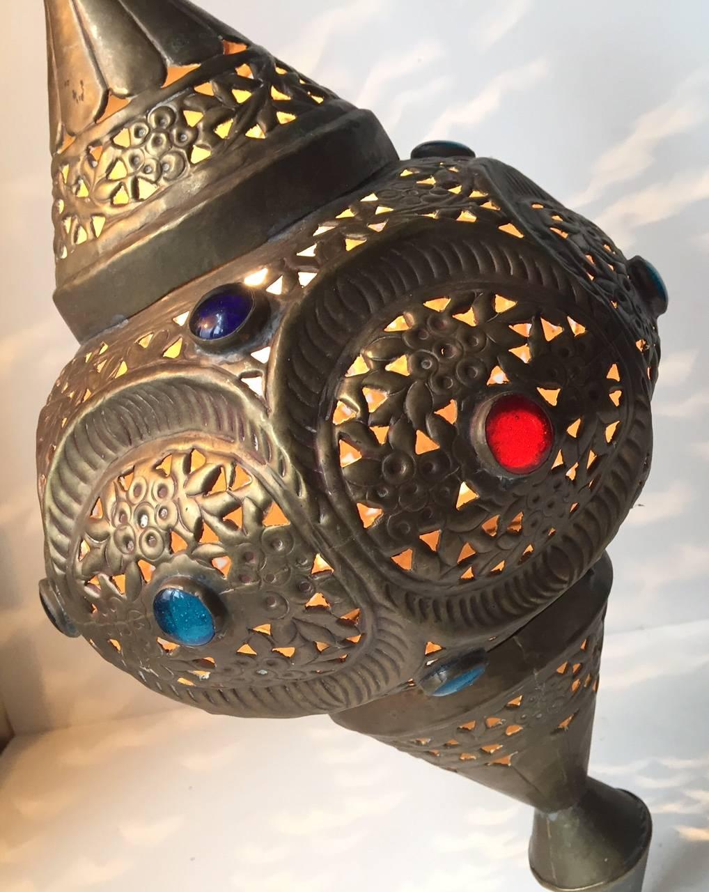 Beautifully handcrafted Moroccan lamp finely chiselled and bejeweled by Moroccan artisans in Marrakech. When lid this light creates small fire-flies that inhabit the surrounding areas.