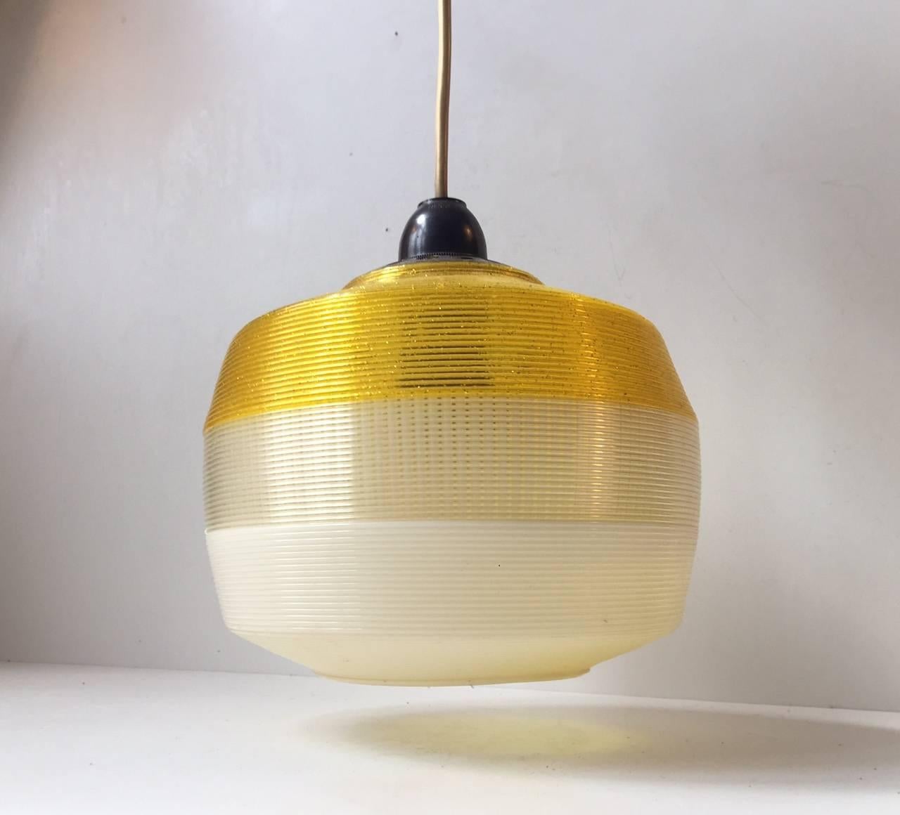 This three-colored pendant lamp manufactured by Rotaflex was produced in France in the 1960s. The lamp is made from acrylic and features horizontal full-body ribbings. The lamp is in good original condition and ready for use.