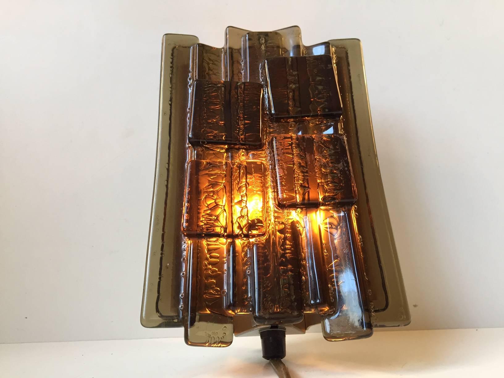 These vintage 1970s Danish Brutalist wall lamps were designed by Claus Bolby and manufactured by his own lighting company Cebo Industri of Silkeborg, Denmark in the late 1960s-early 1970s. The lamps have been constructed from layered strips of