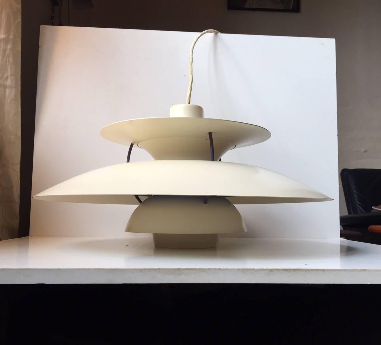 This lamp was designed in the 1950s by Poul Henningsen for Louis Poulsen in Denmark. The piece was designed with the dining room in mind; after mathematical calculations, Henningsen created a lamp which will give maximum light, without seeing the