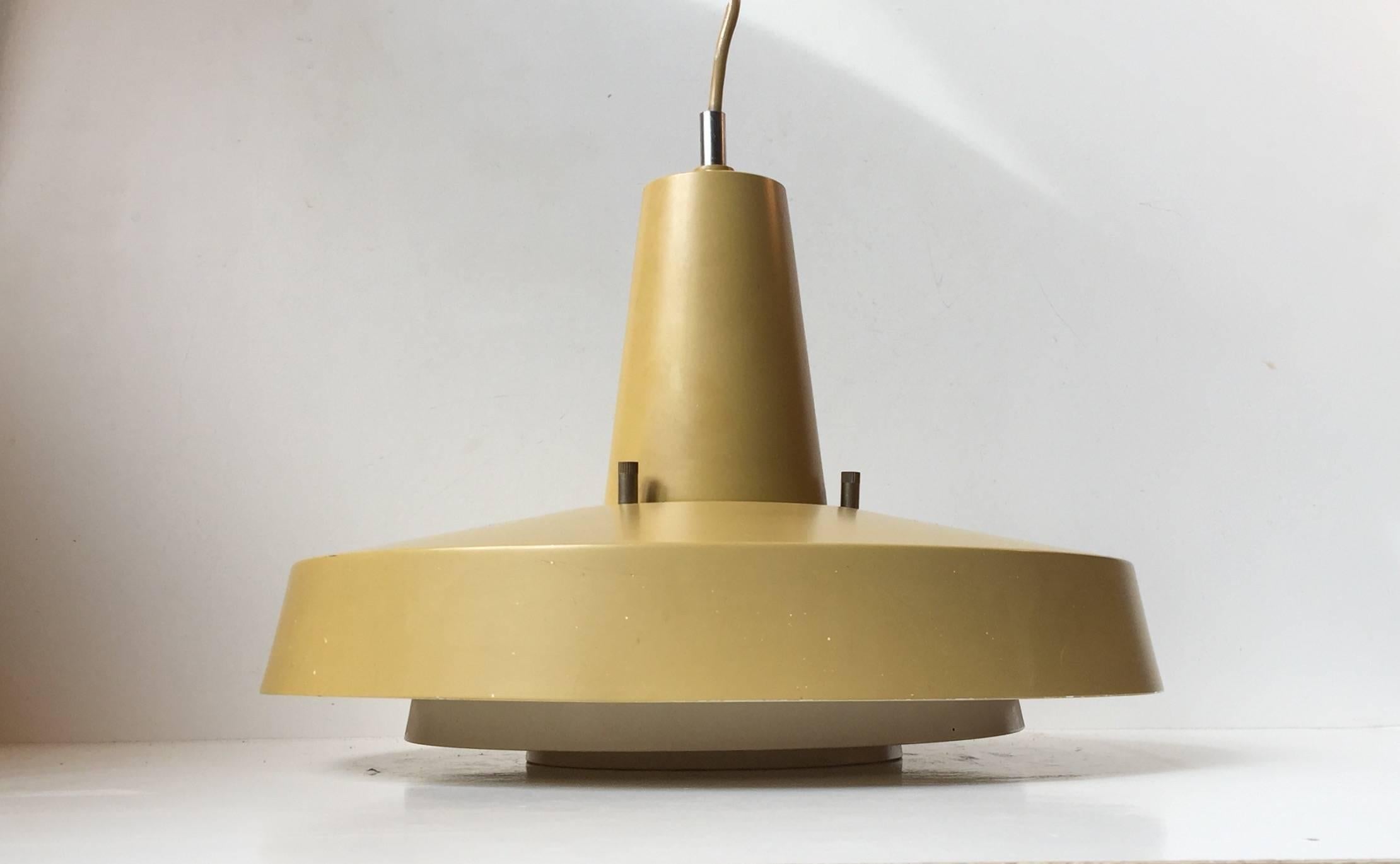 This matté mustard/yellow hanging light was manufactured by Lyfa in Denmark. It was designed by Eva & Nils Koppel in the mid-late 1960s. It features the original porcelain fitting suitable for E27 lightbulbs up to 100 watts.