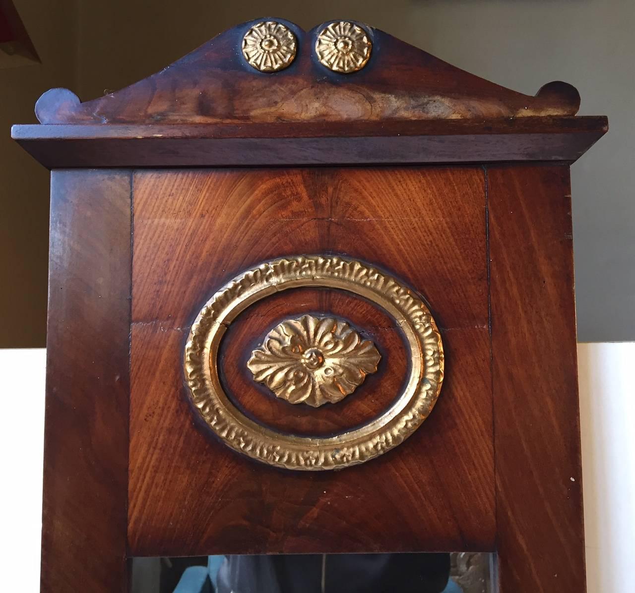 Mahogany wall mirror with gilt detailing. Manufactured in Denmark in the early to mid-19th century.