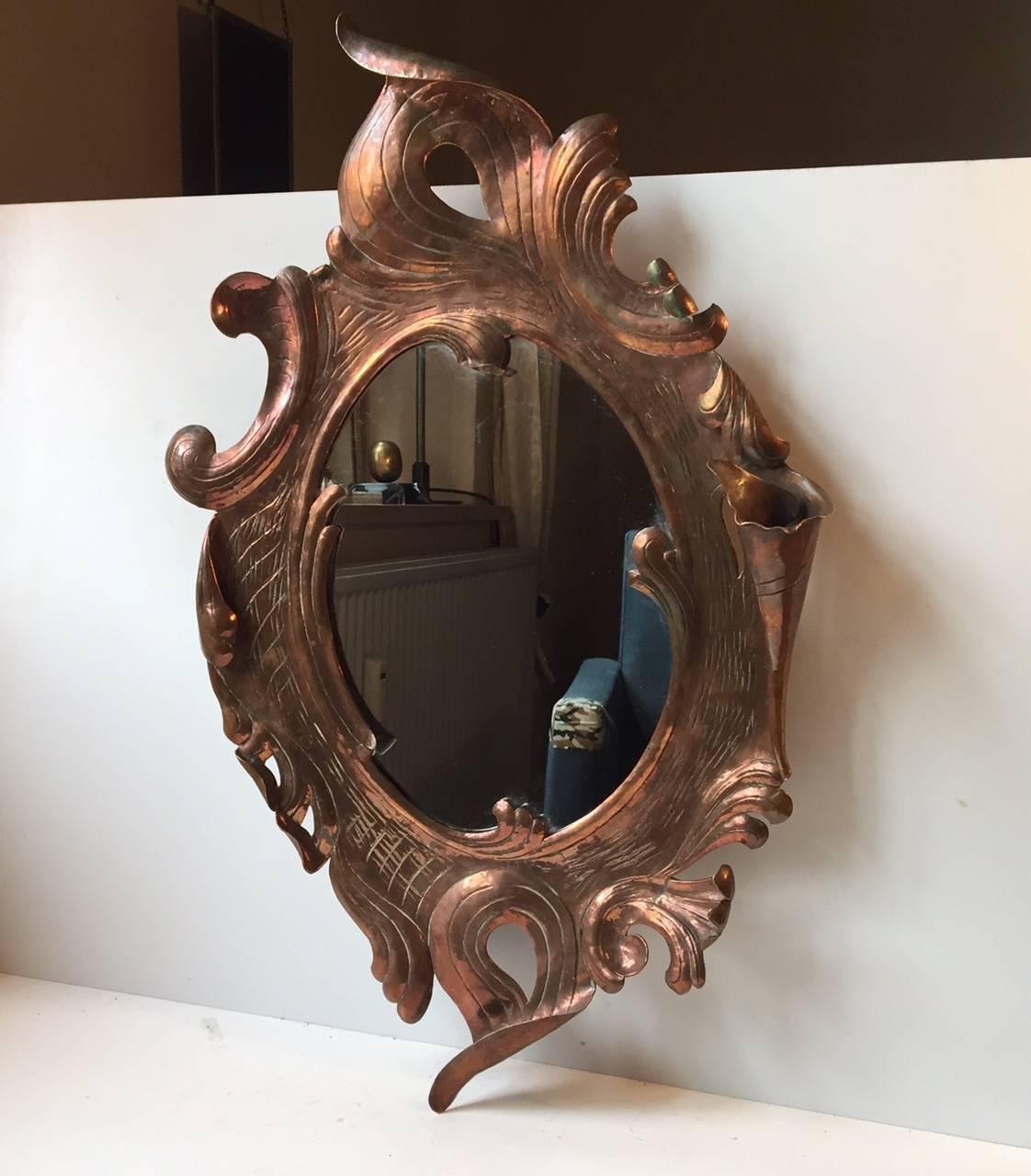 Fine French wall mirror crafted by hand in the early 20th century. Intricate details to the biomorphic shapes and florally swung details.