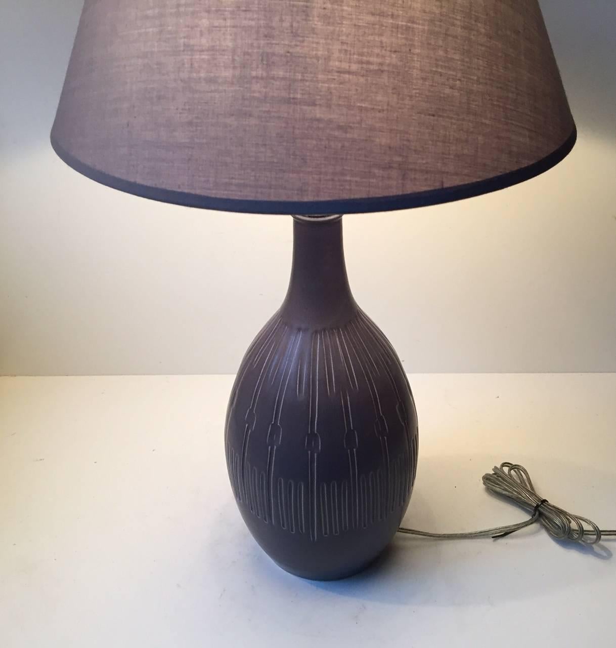 Designed by unidentified Danish ceramist during the 1970s this large gourd shaped table light with geometric decor was manufactured by Søholm in Denmark during the 1970s. It has the number 3000 and is fully marked to the base. It is fitted with a