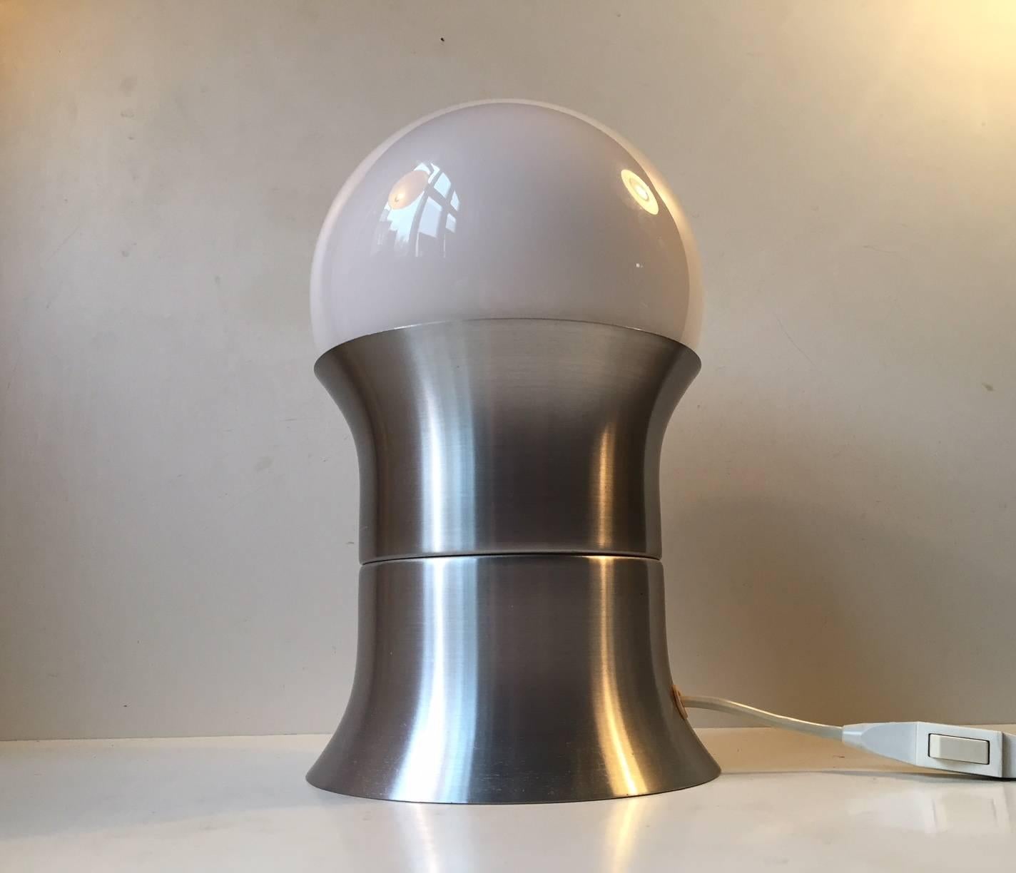 A danish Space Age table light called 'Formland'. Made of brushed aluminium and opaline glass. It was designed in 1970 by Sidse Werner & Leif Alring and it was manufactured by Fog & Mørup in Denmark for a short period of time. It is very similar in