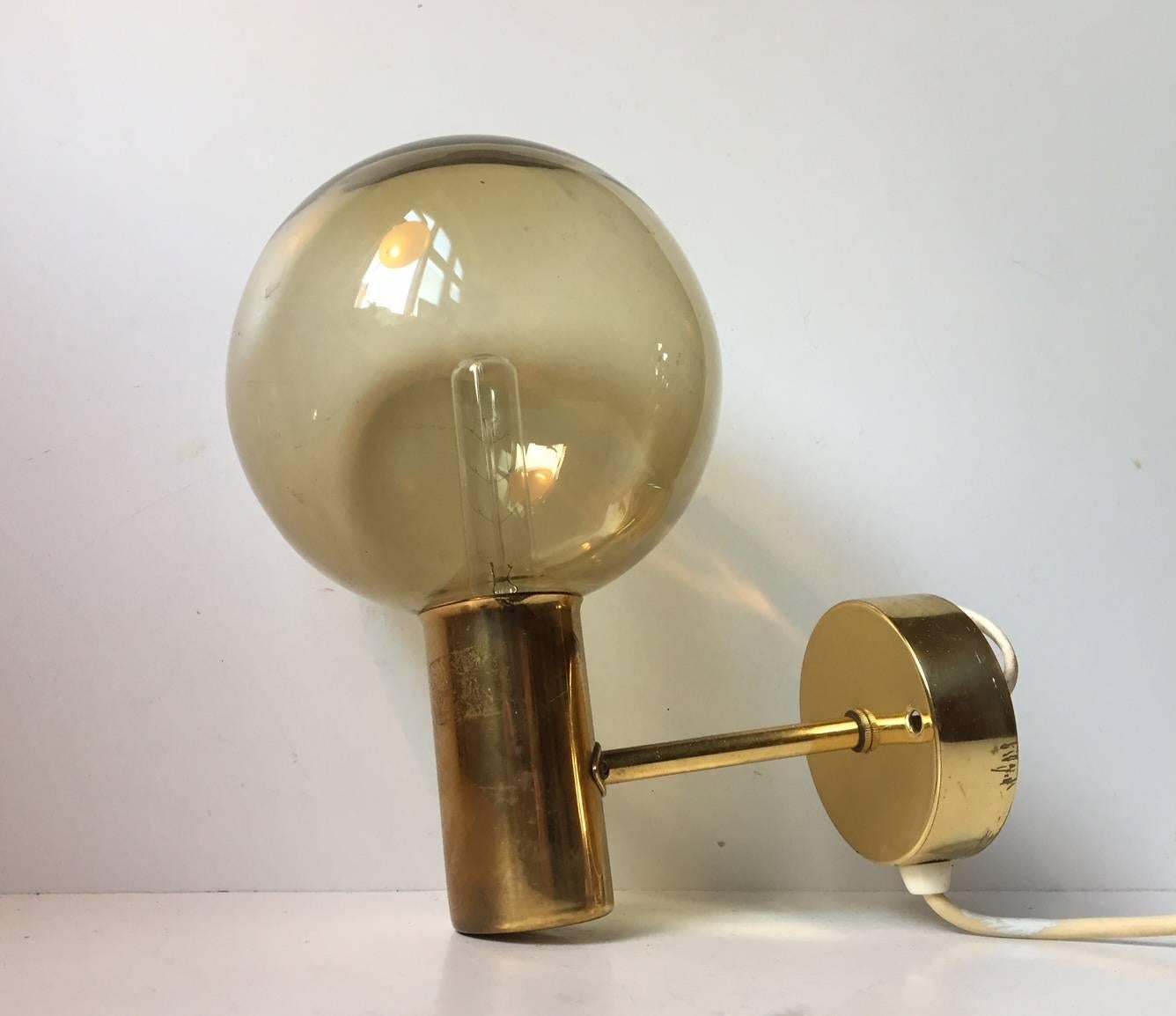 Spherical glass shaded sconce designed by Hans Agne Jakobsson and manufactured by Markaryd AB in Sweden during the 1960s. The model is called V149. Maker/design label still present to the backside of the mount.