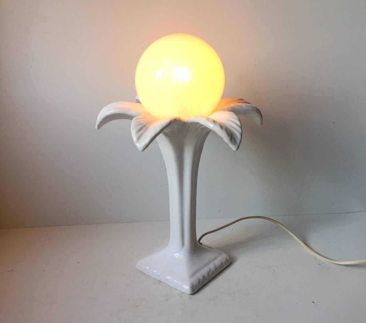 Danish palm three shaped pottery table light. This light with is distinct art deco styling was designed by Michael Andersen & Son during the 1970s. It features a spherical opaline glass shade.
