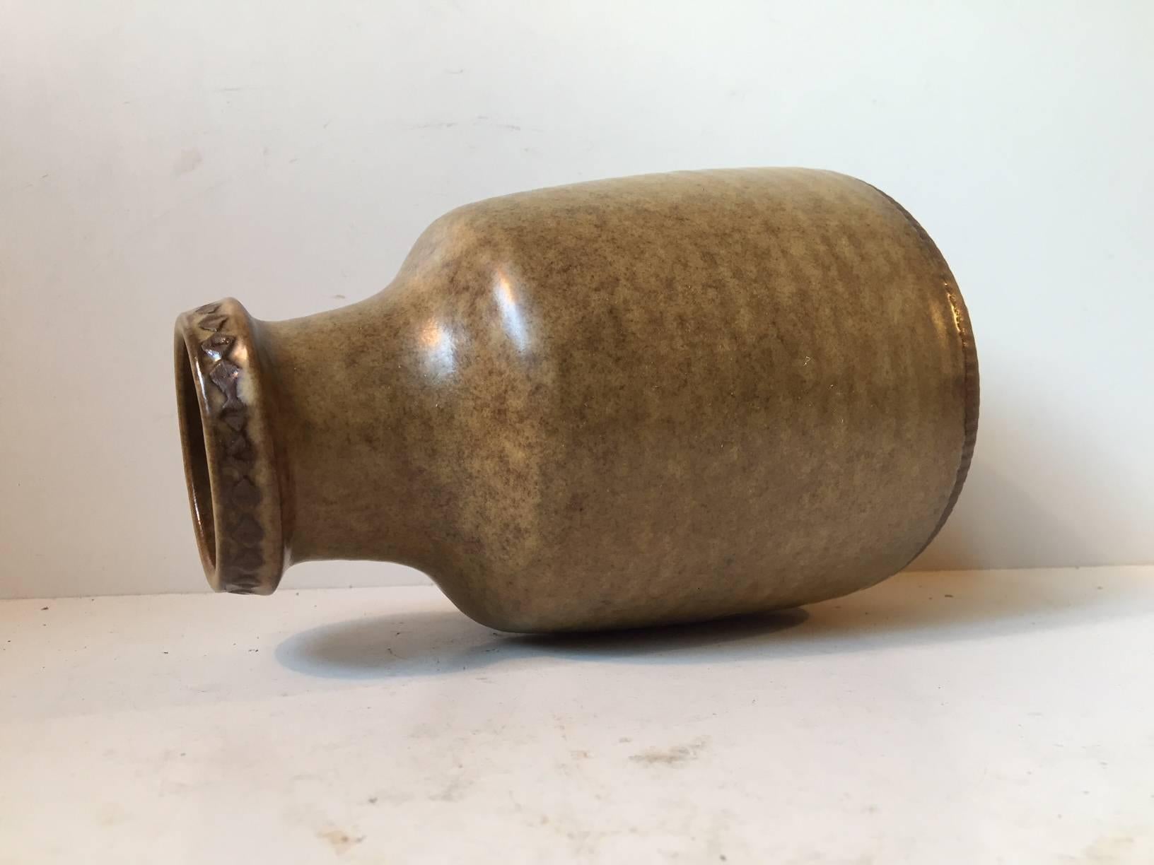 This large ceramic vase in earthy glazes was designed by Swedish Ceramist Gunnar Nylund and manufactured by Rörstrand in the 1960s. The vase is fully signed and stamped by hand on the bottom.