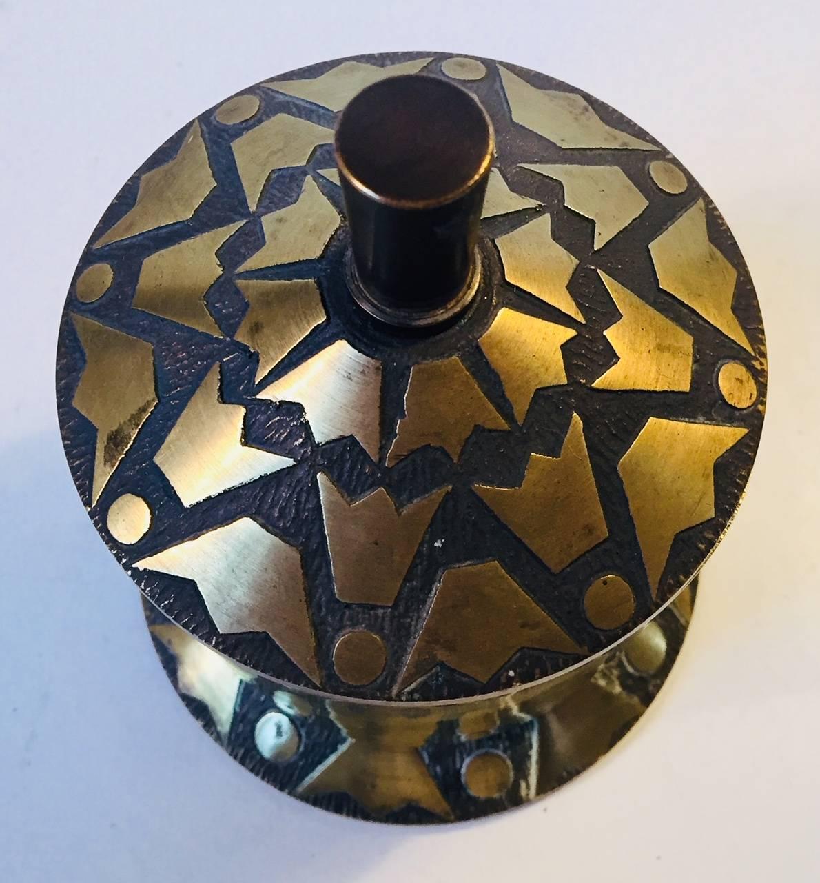 Lidded bronze jar, trinket or cigarette container decorated with crown motif's. Manufactured and designed by Nordisk Malm in Denmark during the 1940s in a style reminiscent of Tinos and Argentor. The piece has a shallow engraving to the side that