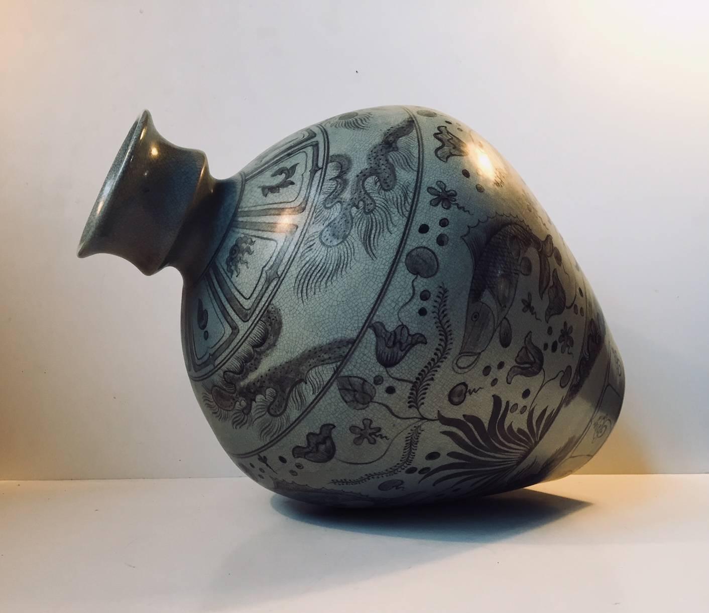 Large balloon shaped vase in grey craquele glaze decorated with hand-painted black motif's of fishes and flowers. Created by Lyngby Porcelæn in Denmark during the 1930s.