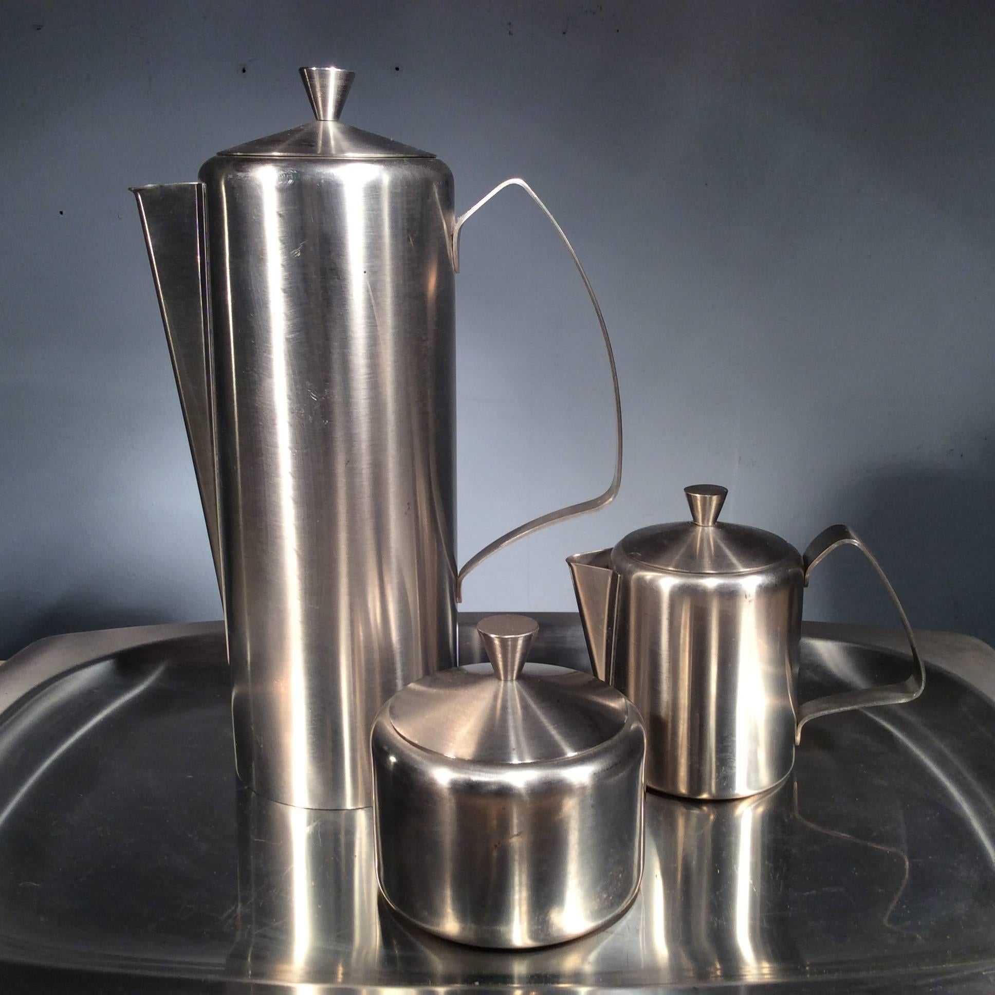 This stunning vintage 1960s stainless steel coffee service is stamped 'made in England' and made by 'Tudor Knight'. 

Complete with an elegant tall coffee pot, milk jug and sugar pot, it screams Mid-Century Modern.

Dimensions:

Tray: Height