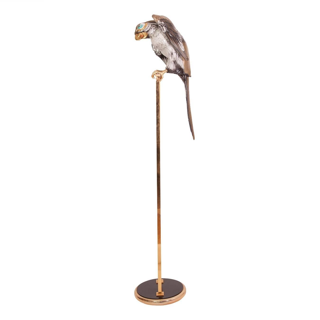 Beautiful ceramic-enameled parrot perched on brass stand.