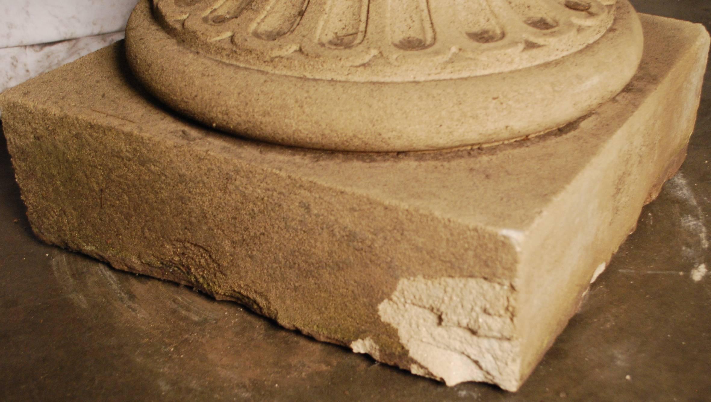 French stone urn with carved ram head detailing.