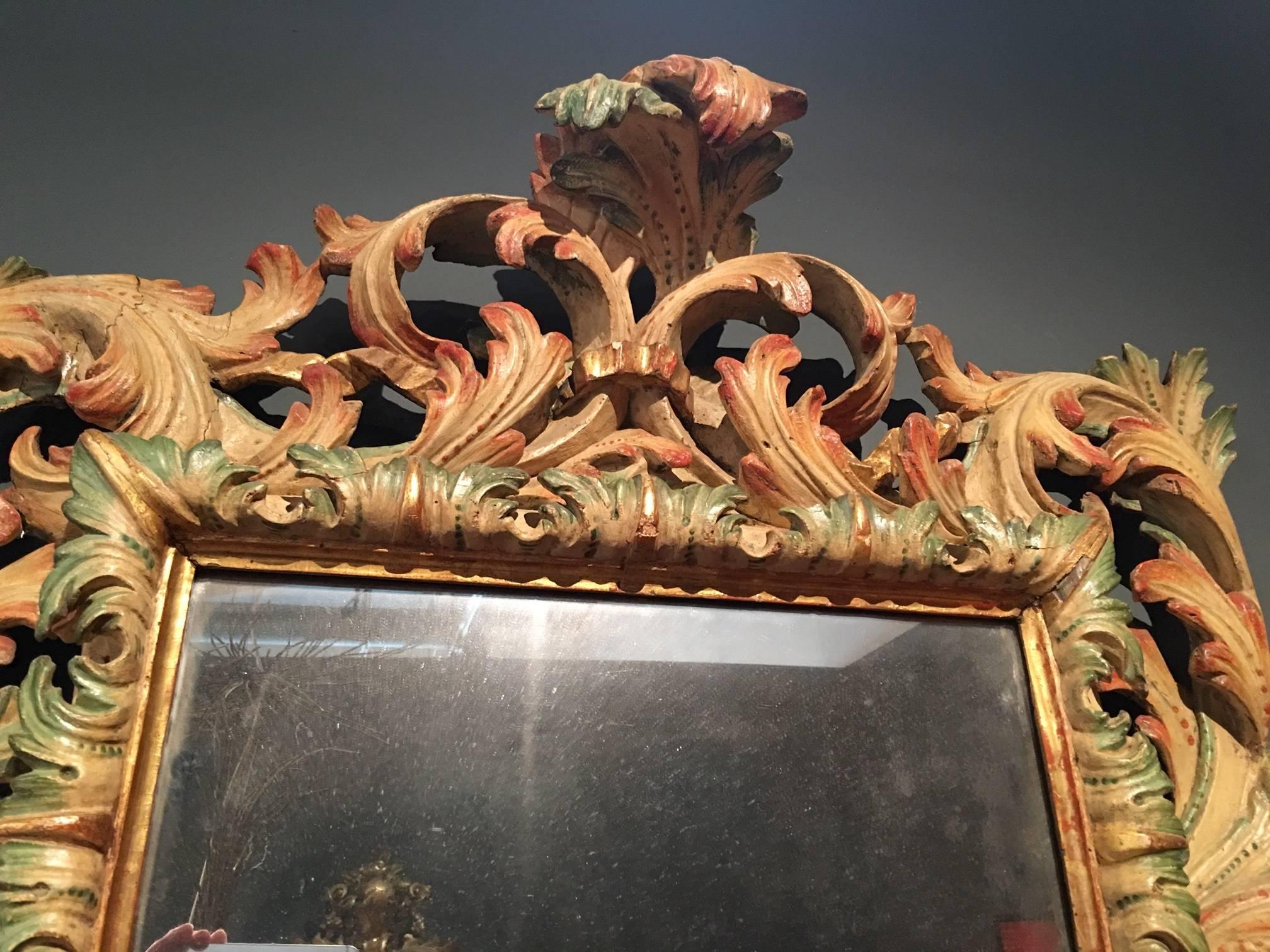 Its masterful foliate carved and polychrome frame with an unusual palette of color; most probably made for an important Genovese family.

Italy (Genoa), circa 1725.