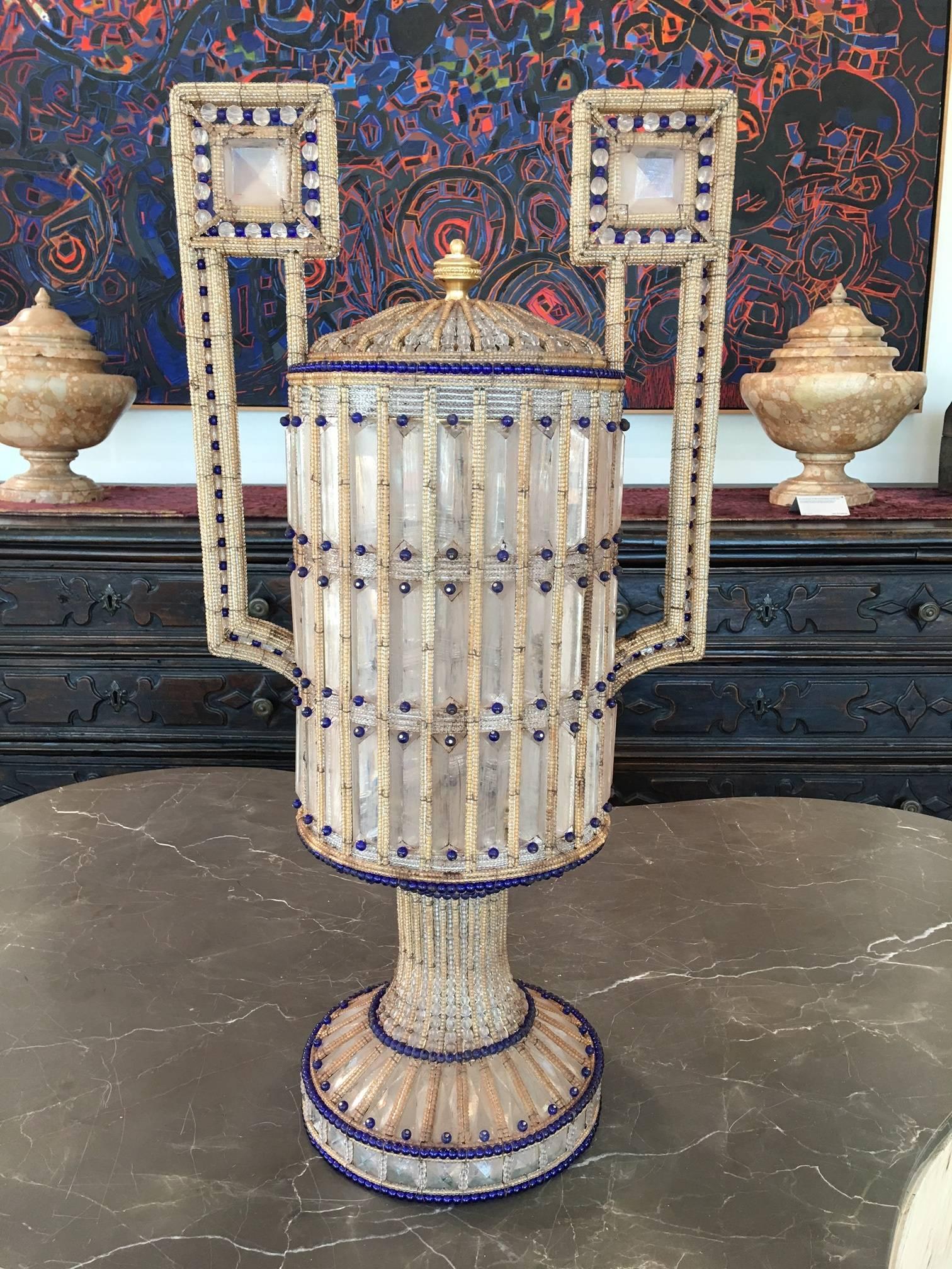 Each with a pair of Greek key-inspired handles. Their bodies comprised of elaborately strung geometric compositions of prismatic opaque glass with caramel and royal blue beads. Lids removable and all in a state of perfect condition.

Venice, circa