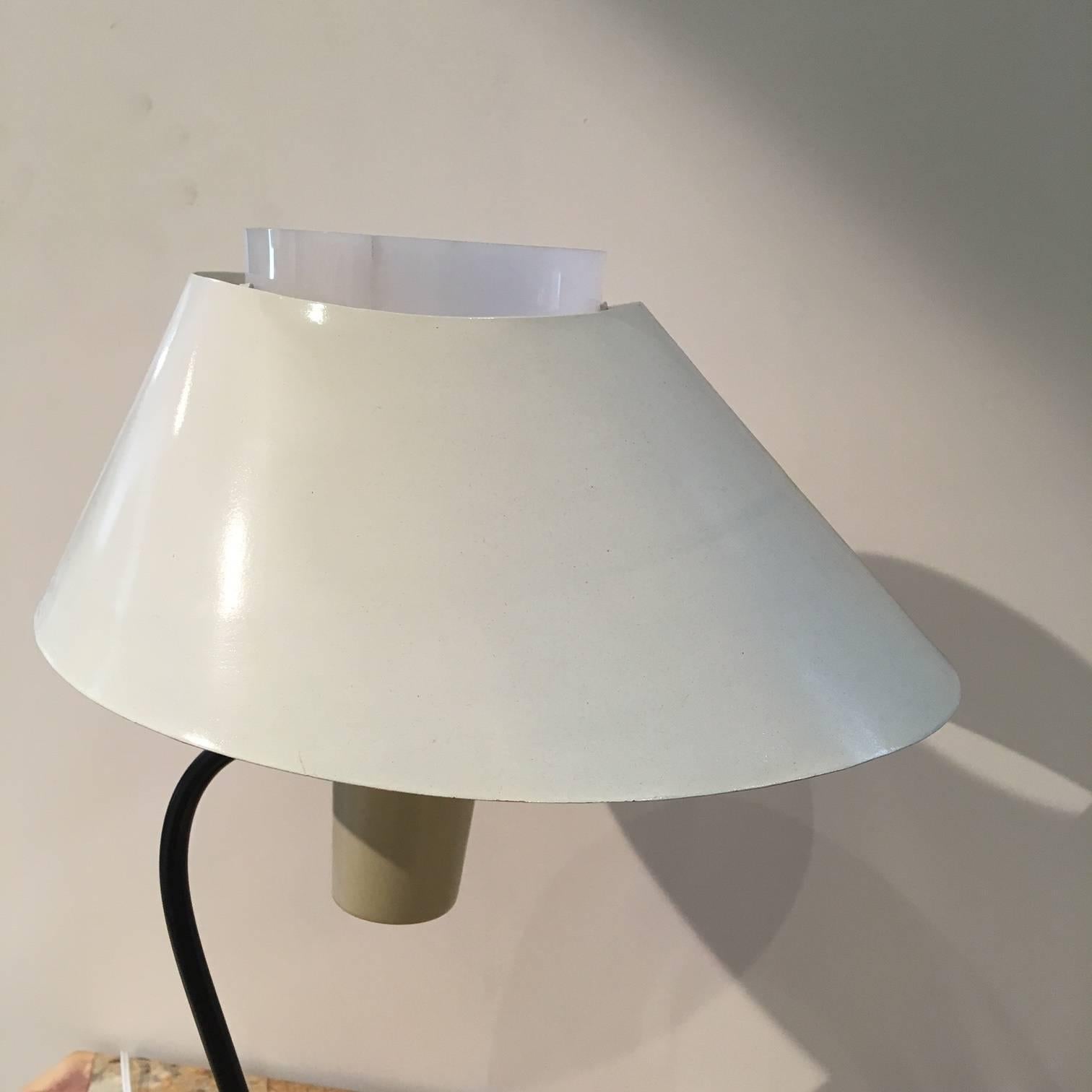 Desk or table lamp with a black tubular stem that supports the shade and two diffusers: One in metal that hides the socket and the another in Lucite that softens the light. Commissioned for the Maison du Cambodge at Cité Universitaire.