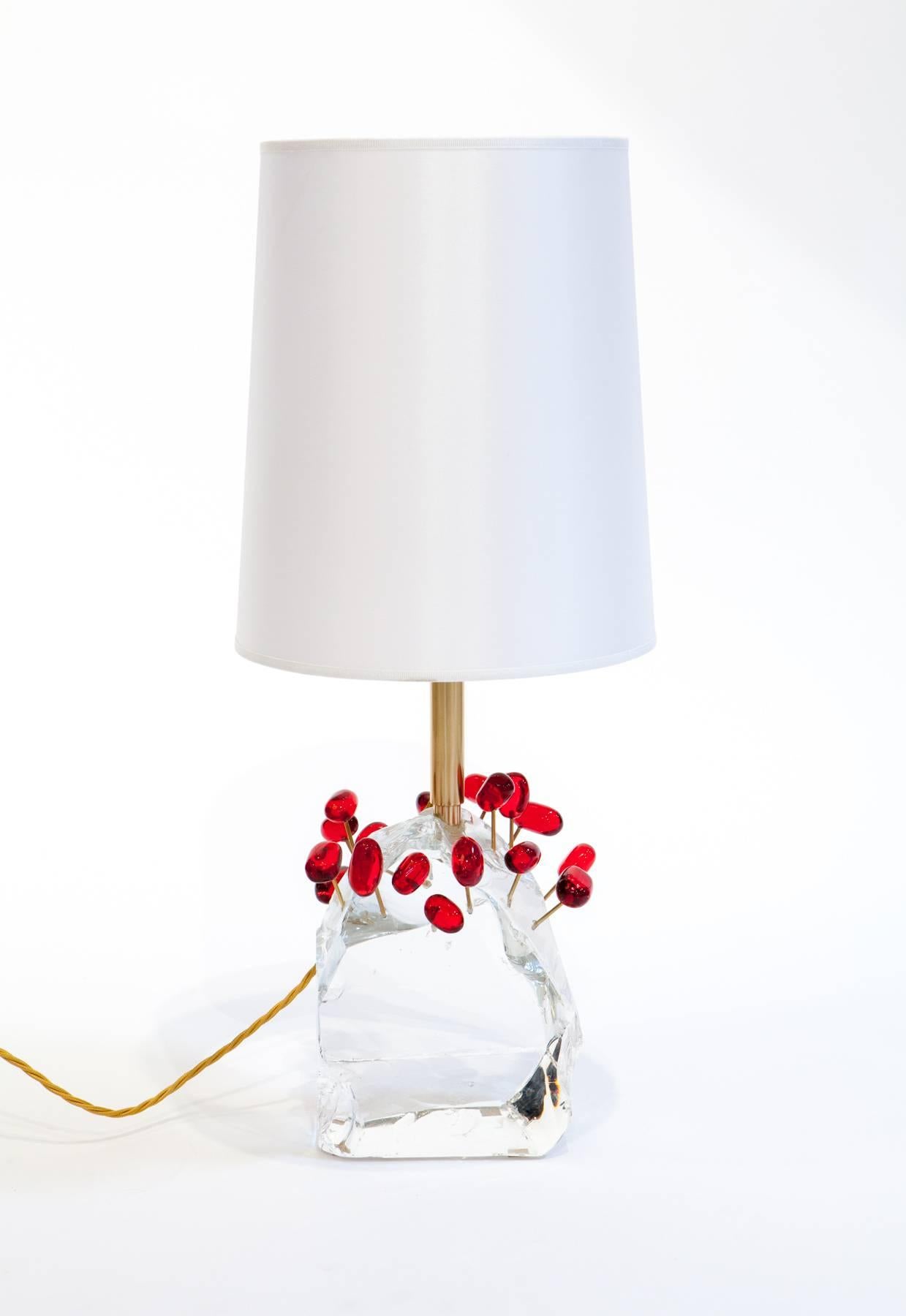 Large block of chiseled and polished glass and decorative glass to resemble cherries. Each lamp fitted with a brass stem and mounted with a silk shade.