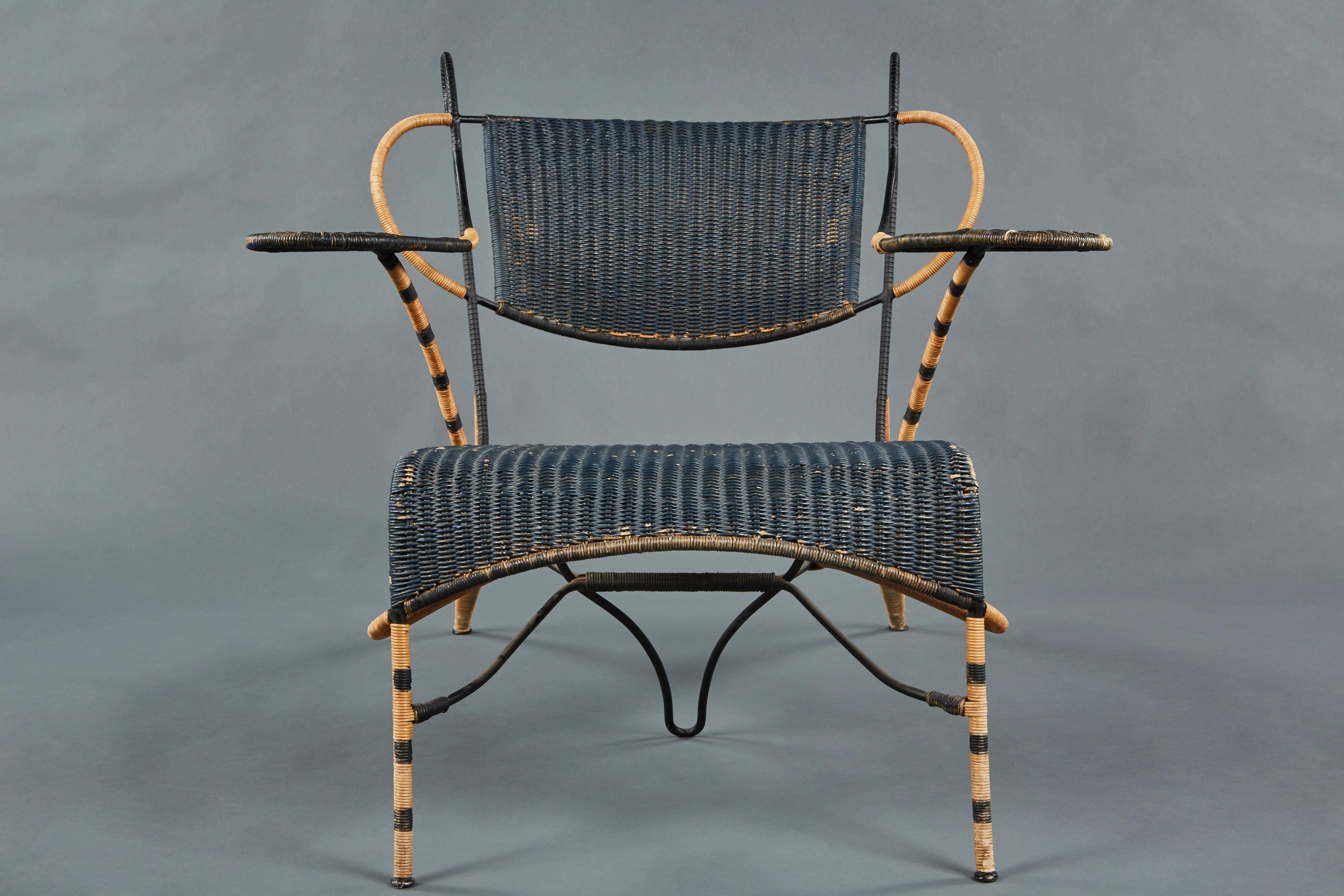 A unique and sculptural Italian black and natural wicker chair over a steel frame. Its flamboyant elements contributing to great movement and flair.
