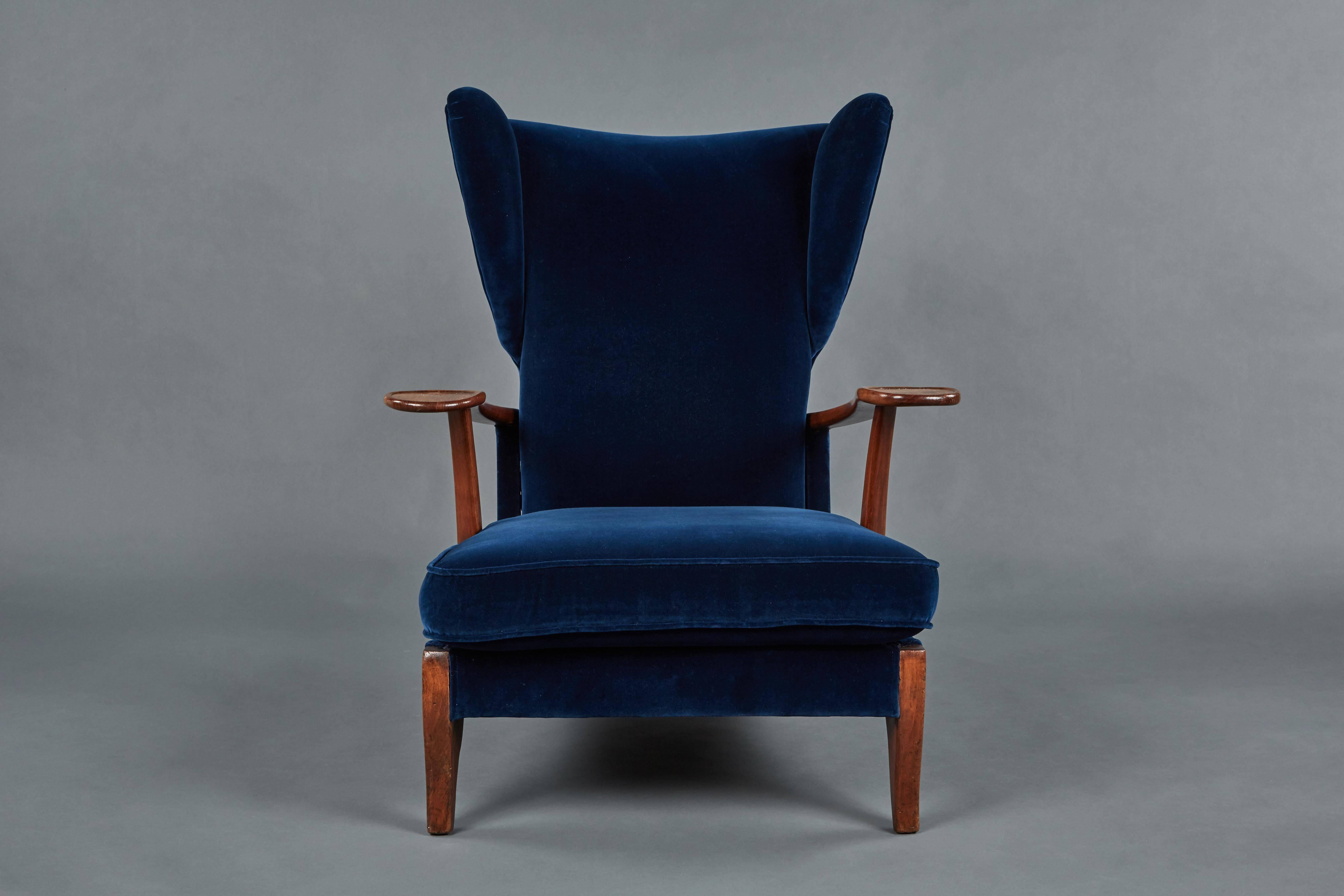 A rare and impressive Paolo Buffa adjustable lounge/armchair, circa 1946. Newly upholstered in a deep blue velvet with cherry wood arms and feet. Back lifts to be set into one of three positions.