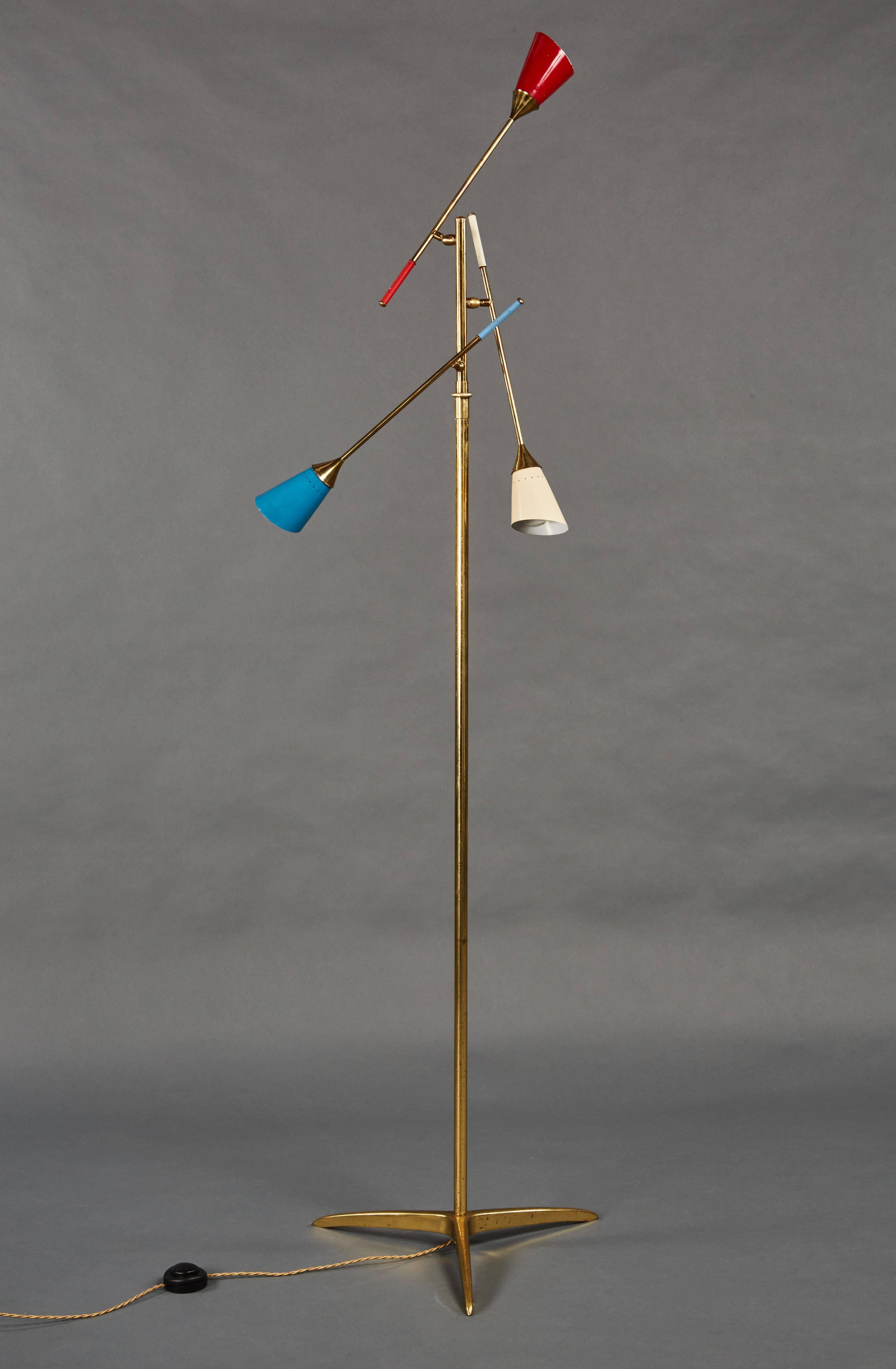 A charming, adjustable Italian floor lamp with tri-colored shades on a brass base.