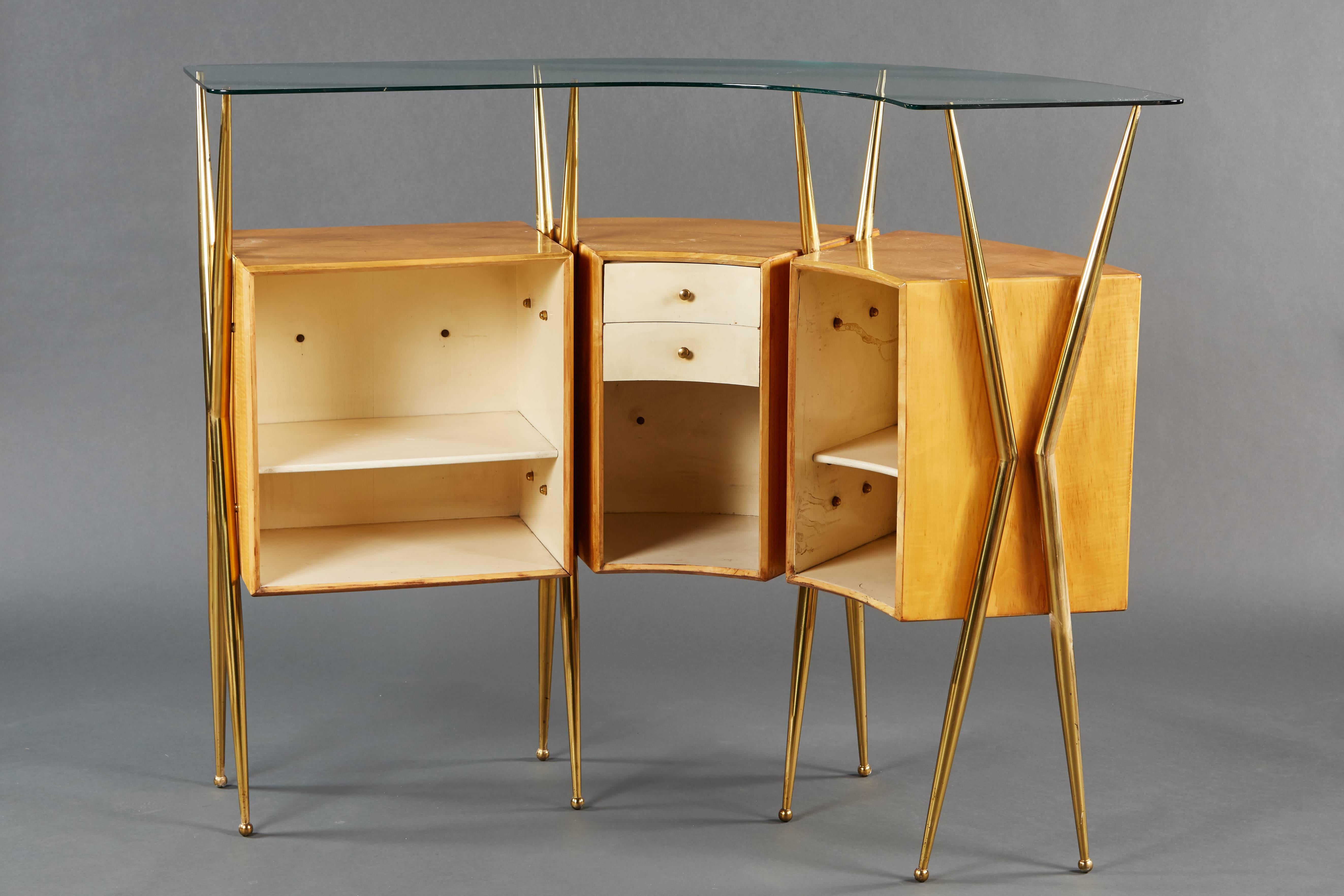 An elegant Italian bar cabinet, featuring a curvilinear design, mounted scenic illustrations and tapered brass legs.