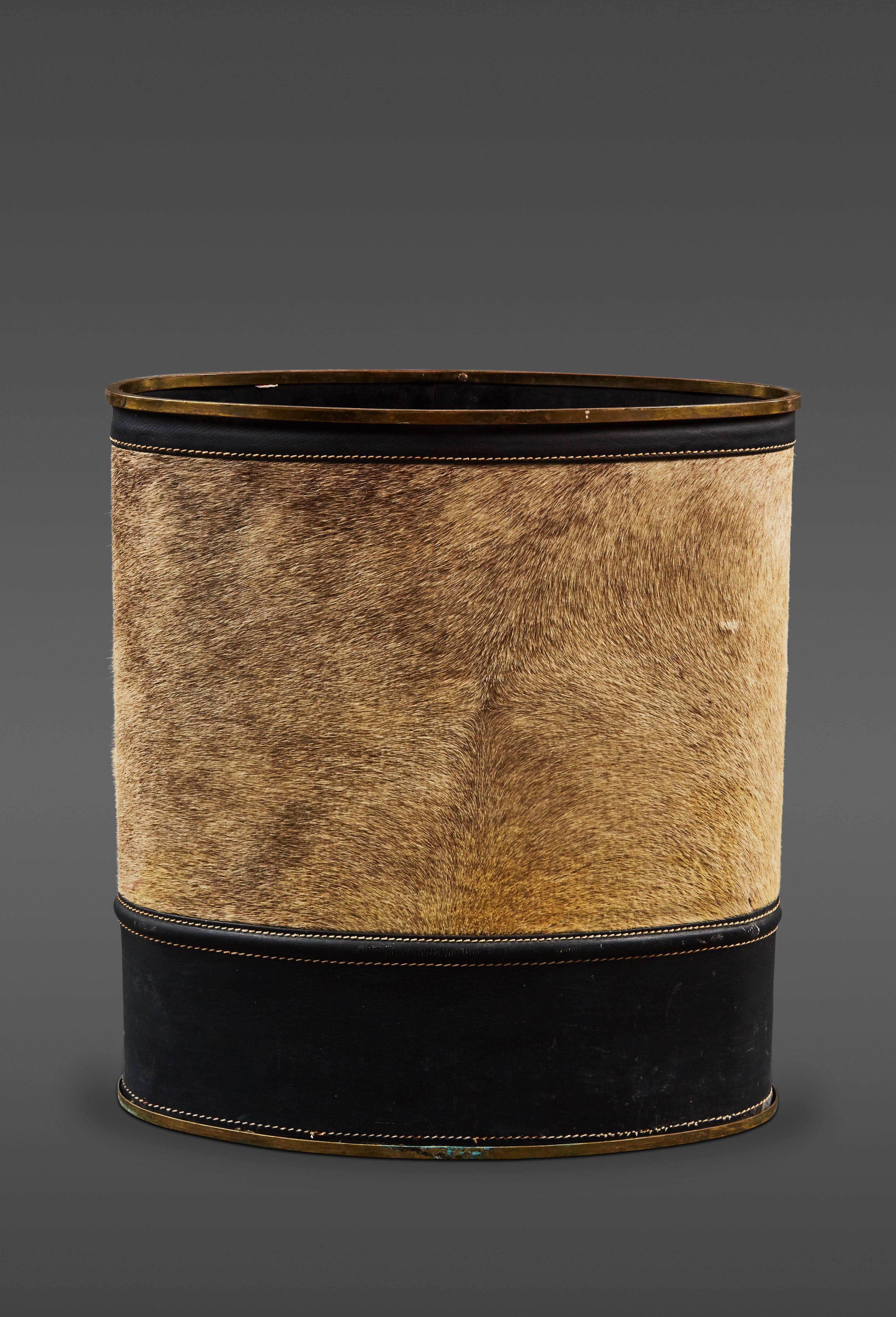 A rare Mathieu Mategot leather and cowhide umbrella stand.