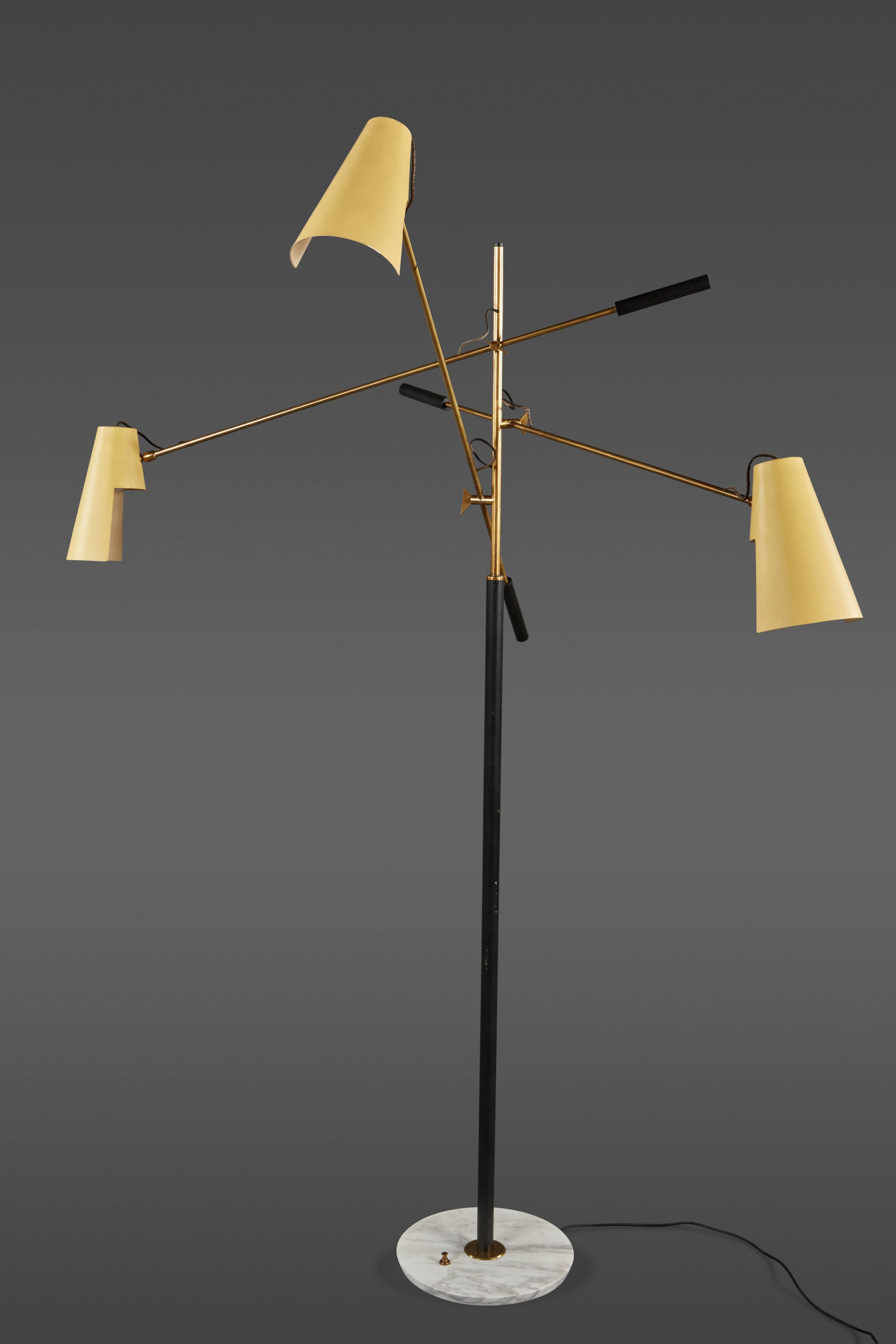 A rare Stilnovo three-arm adjustable floor lamp. Original painted metal shades with brass arms and a marble base.