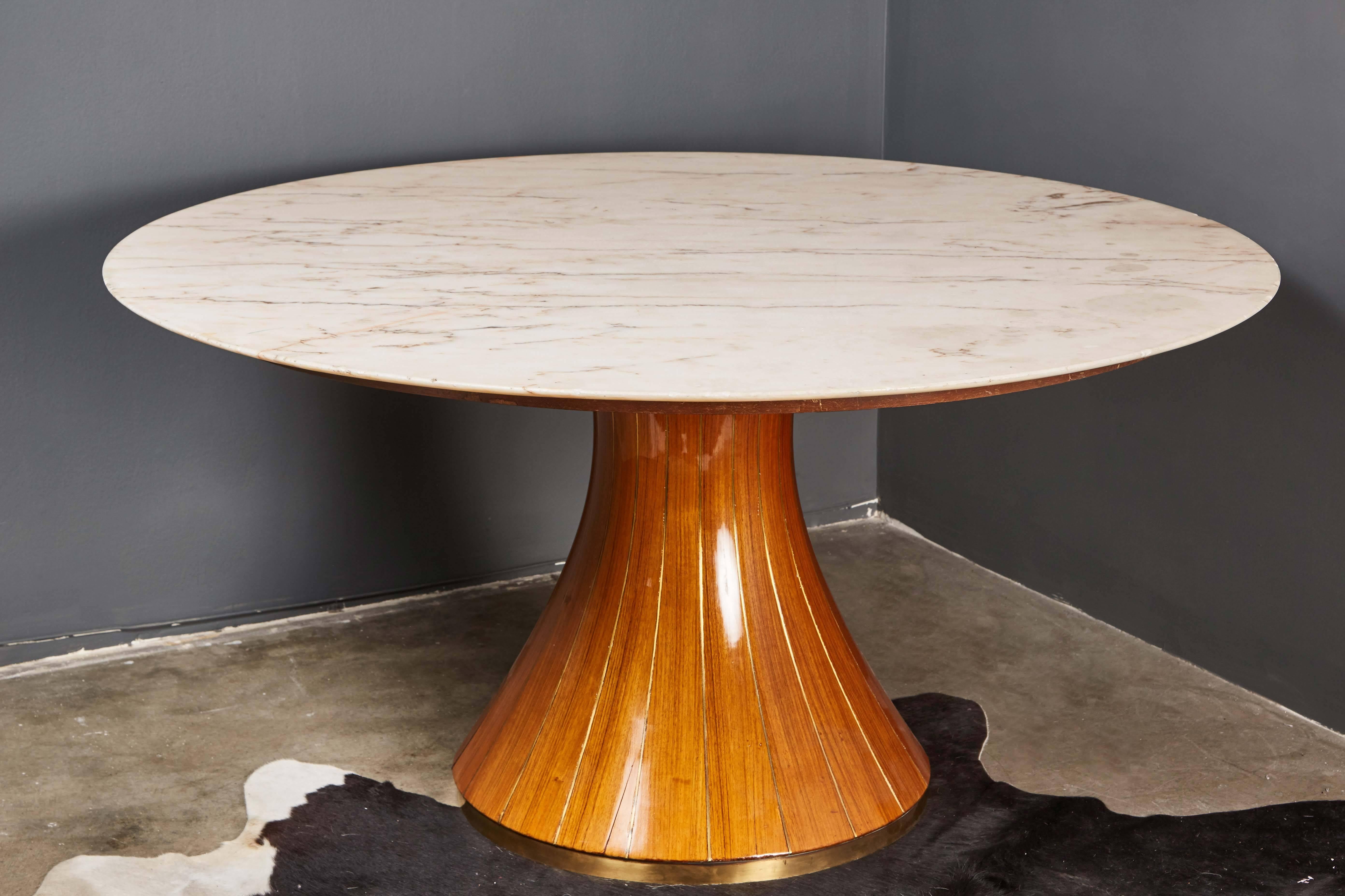 A stunning round centre table attributed to Paolo Buffa, with an onyx top over a walnut base with brass inlay.