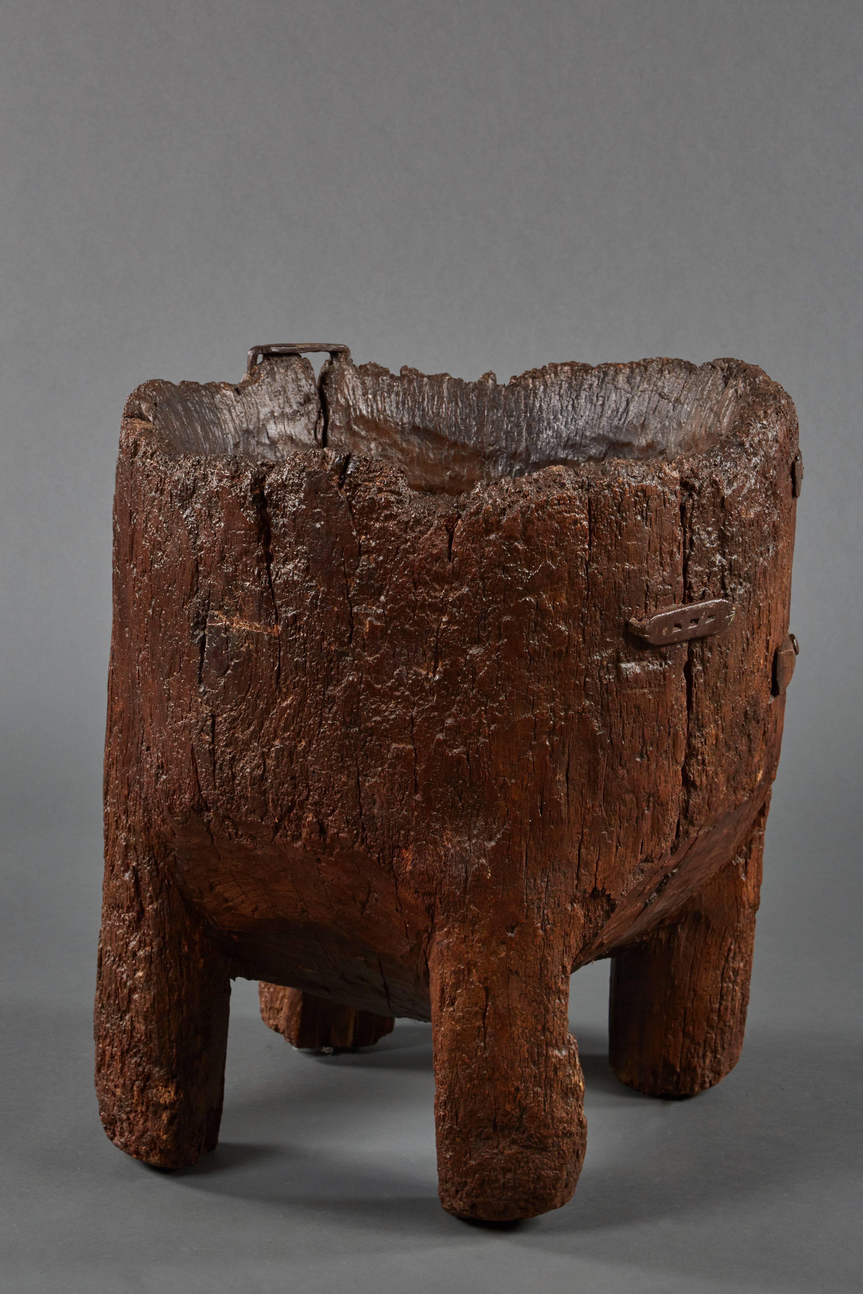 Impressive and grand antique chestnut mortar, its large wood bowl revealing Primitive exterior joints and resting on four weighty legs.