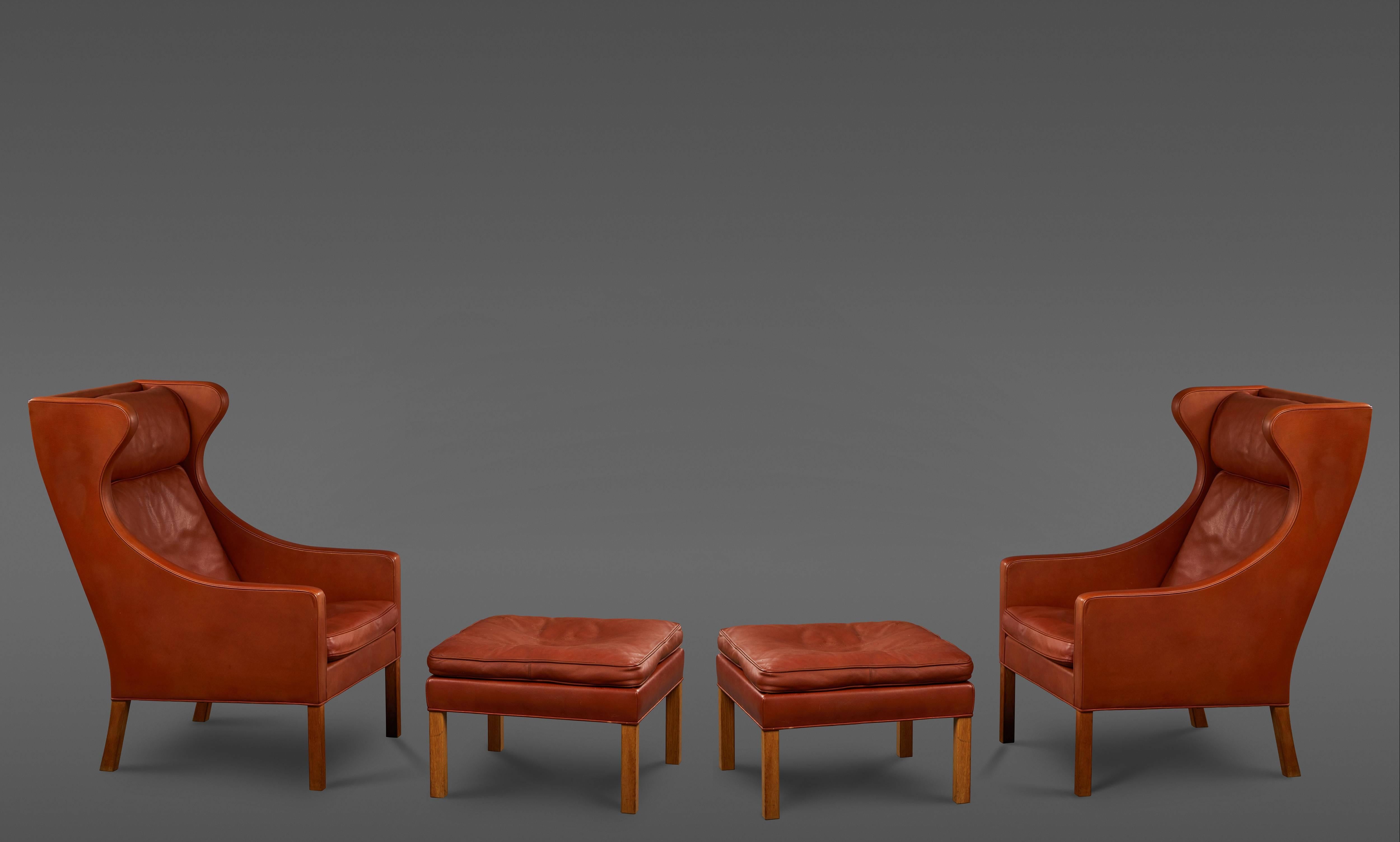 Pair of Børge Mogensen wing chairs with ottomans for Fredericia, in orange (