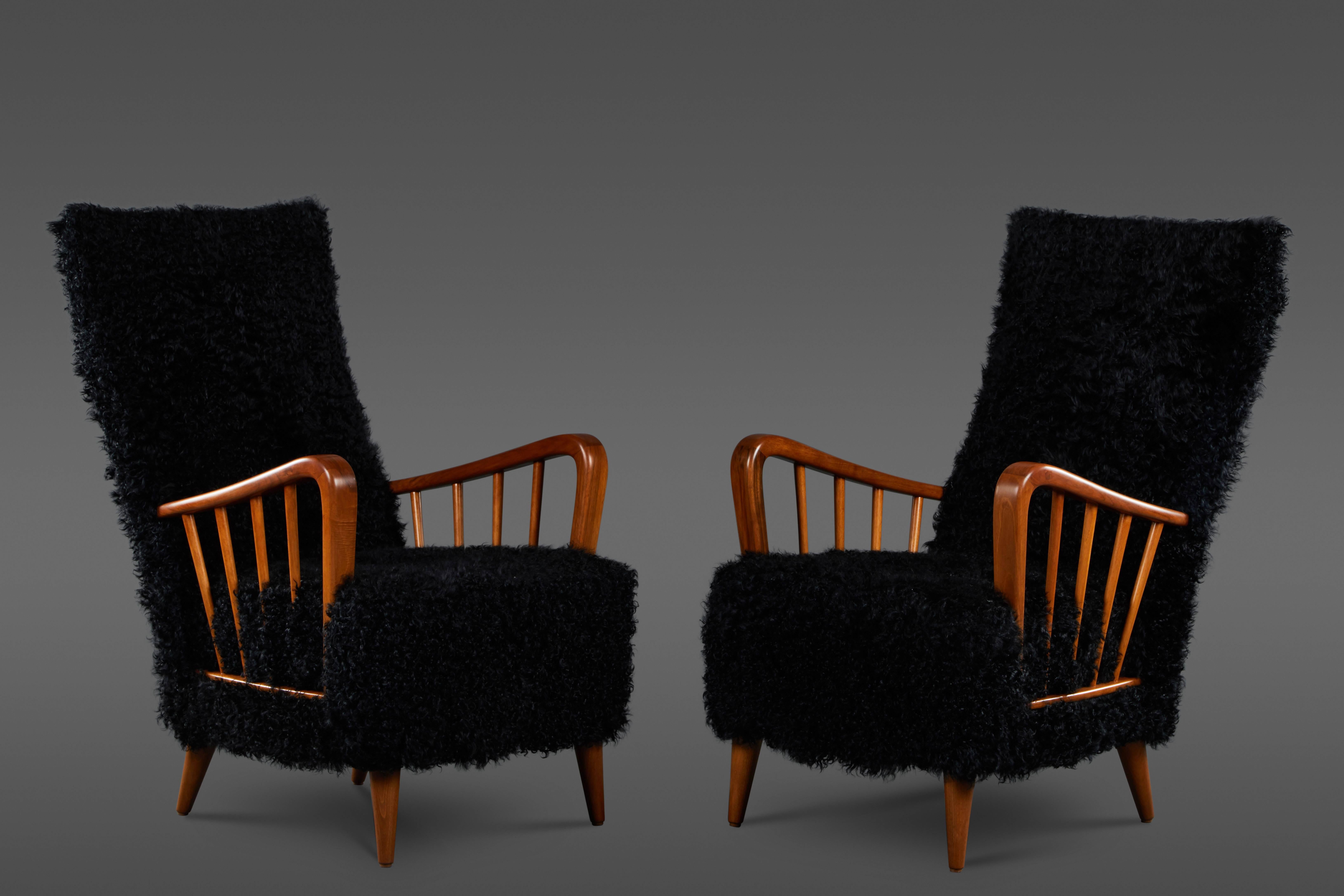 A uniquely upholstered pair of Paolo Buffa chairs in black Kalgan lamb with shaped wood balustrade arms.