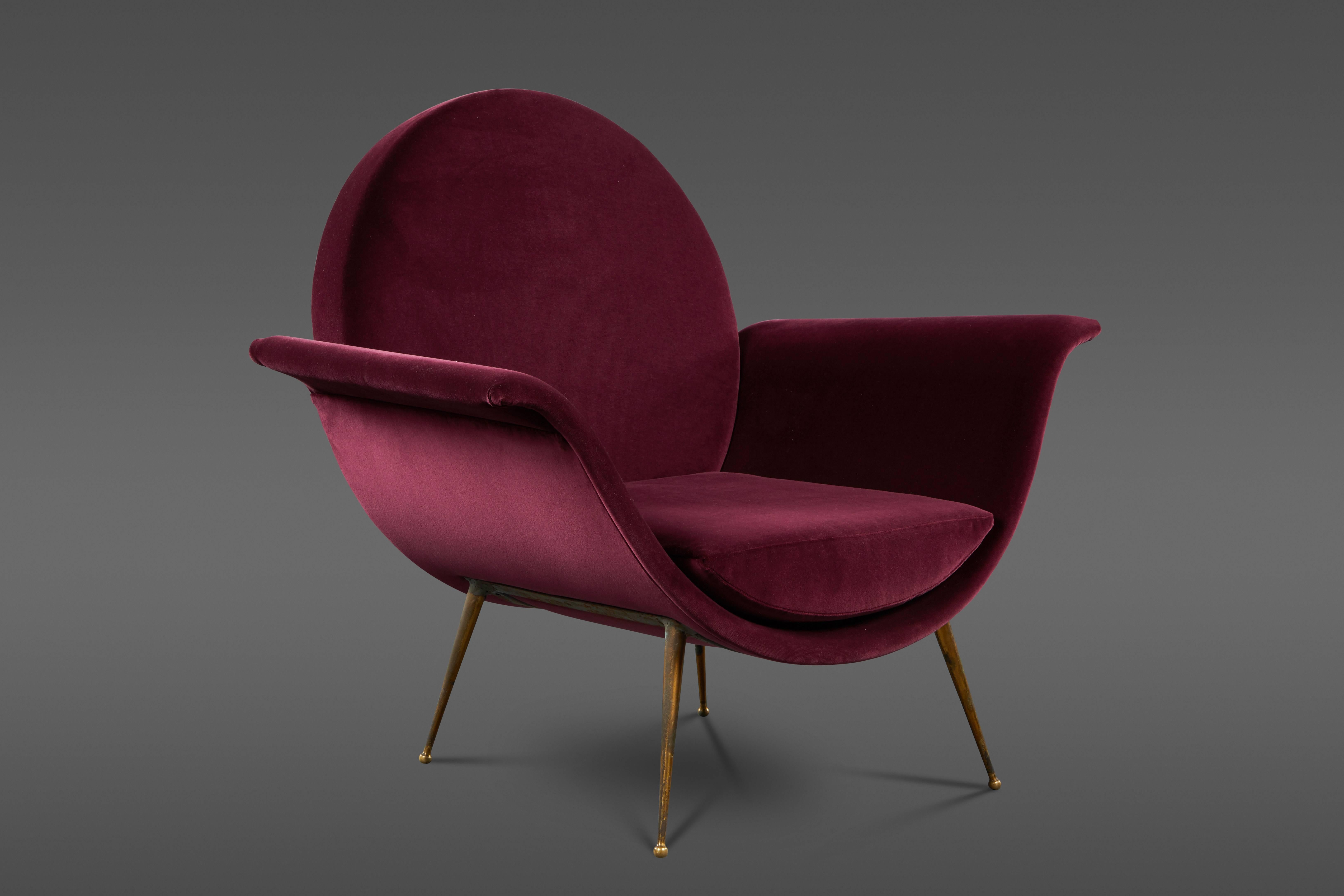 A round back sculptural Vintage Italian easy chair with brass legs, custom upholstered in an aubergine velvet.