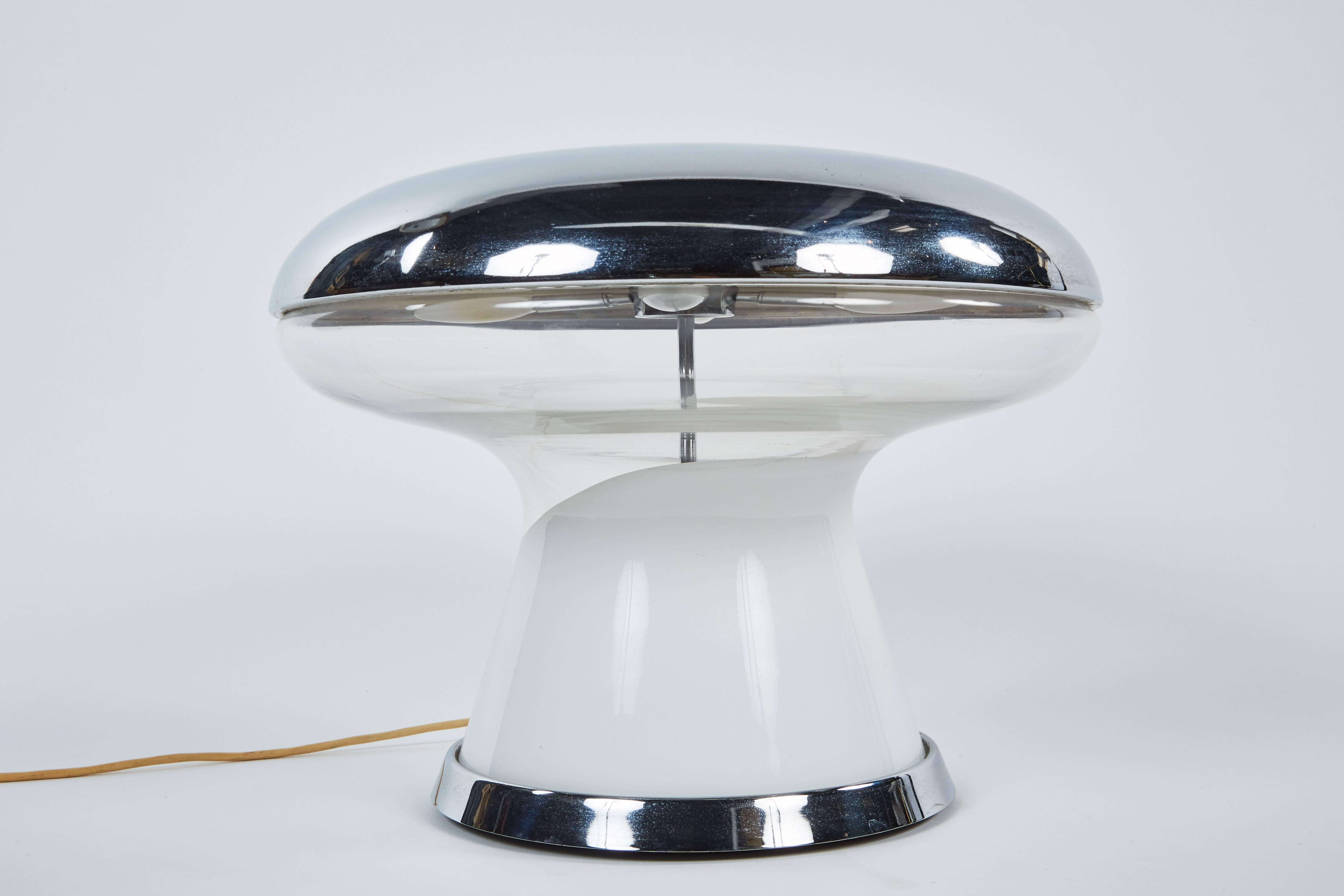 A unique and sculptural Murano blown glass table lamp by Vistosi featuring chrome and opaque glass.