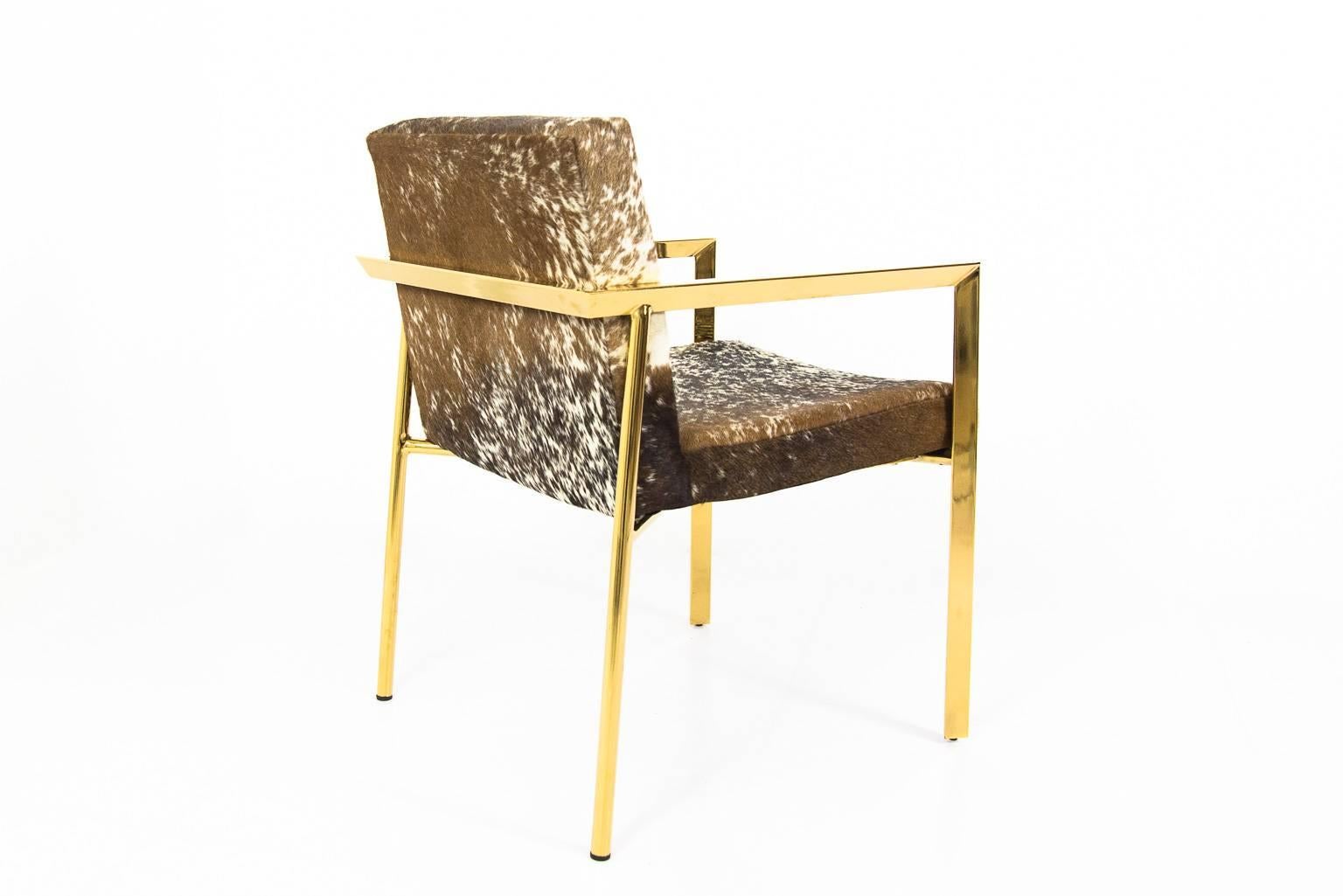 Modshop's Argentina chair is what your home needs. In cowhide upholstery, the brass frame starts off with straight lines in the front and finishes in the back with round legs. Also has slight pitched back
Measures: 21.5