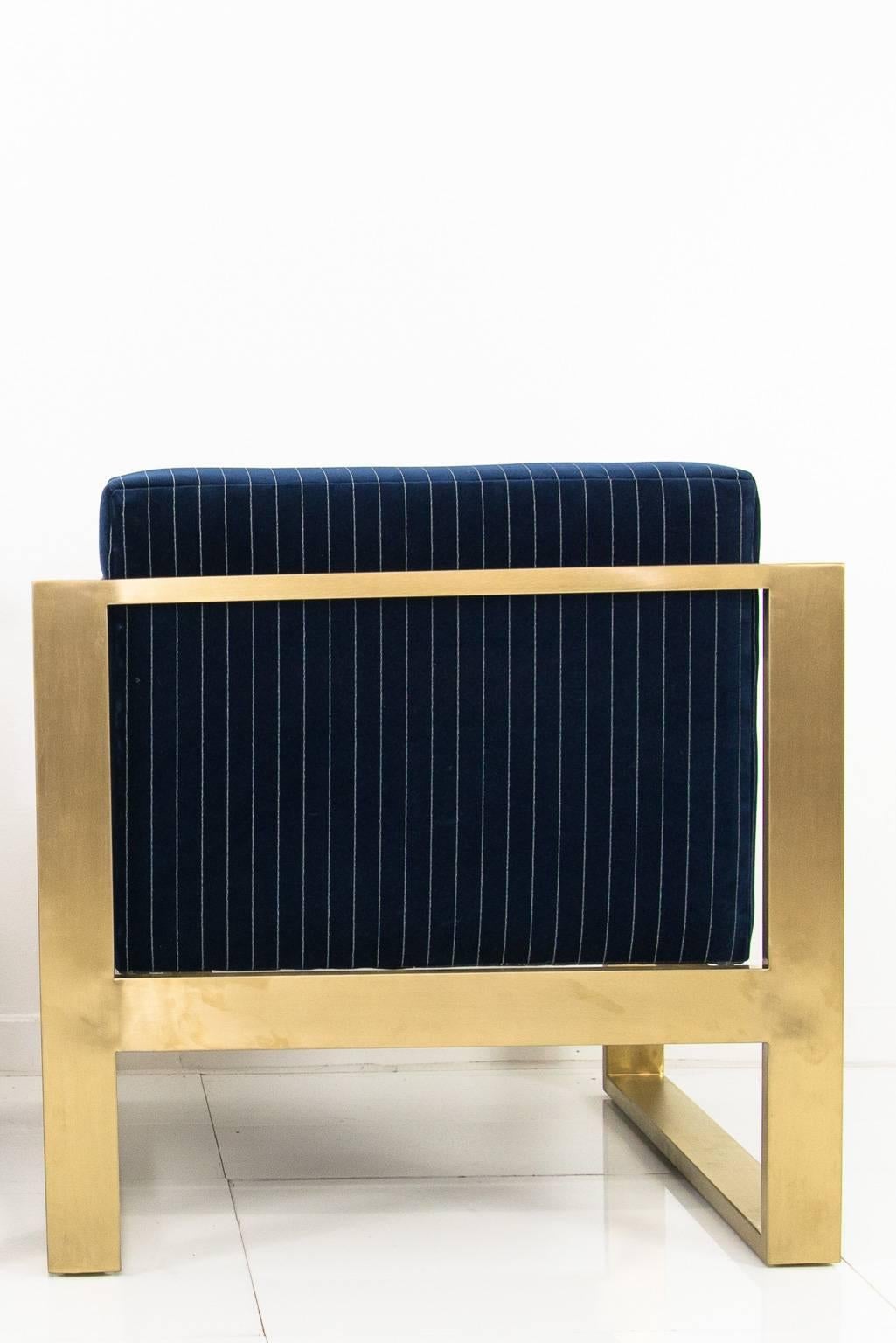 Modshop's Kube chair. Finished in navy pinstriped velvet and a brass U-leg frame.

Measures: 31.5