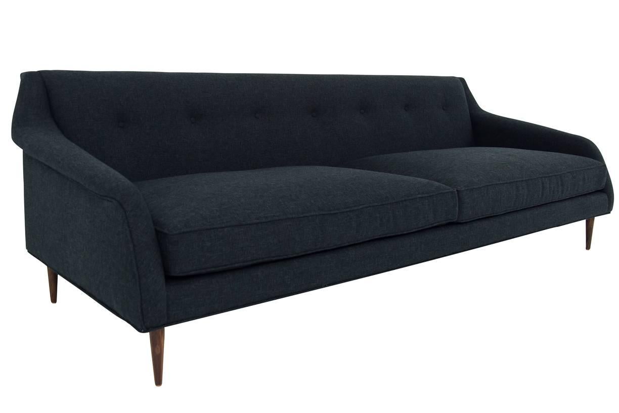 Modshop's Palermo sofa let's you take flight. A stylish Mid-Century Modern styled sofa with a wingspan of 8'. With a button tufted back, cone legs, and armrests that fold out make this sofa the toast of the town. It's a sofa that will be noticed.