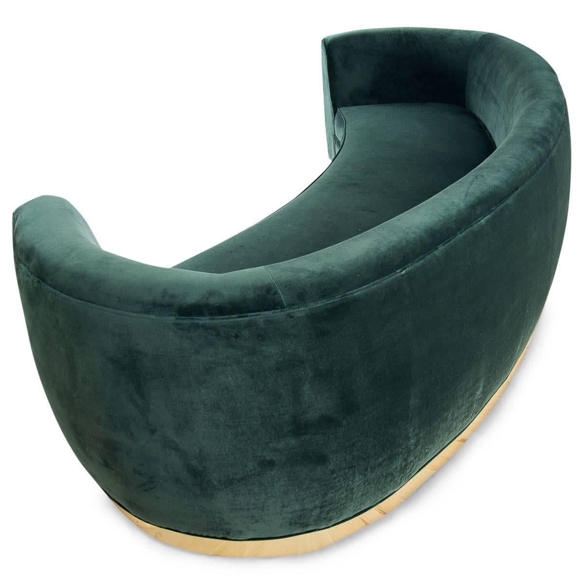 green velvet curved sofa