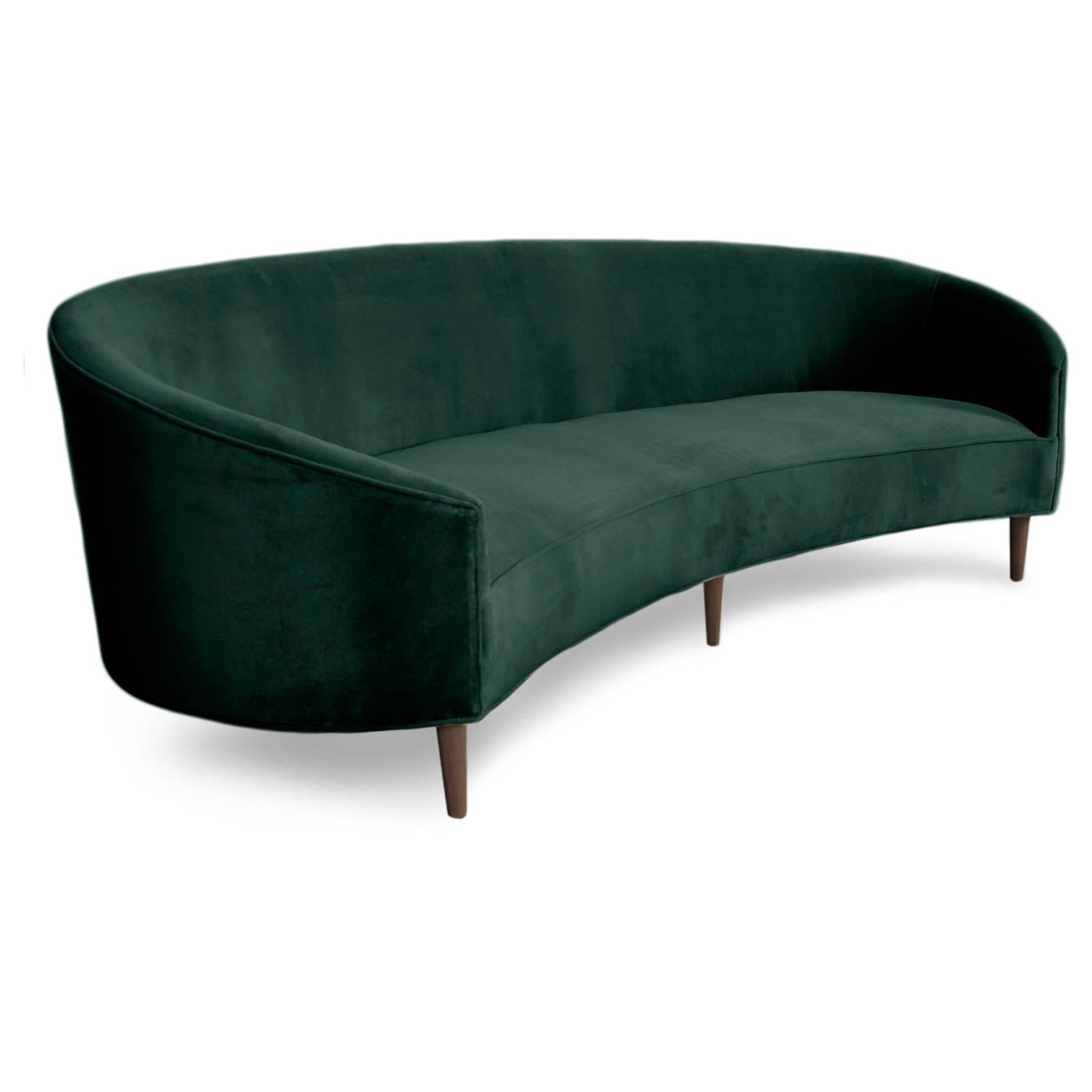 With Classic clean lines and sharp curves comes this Art Deco sofa. Uniquely shaped, similar to a crescent, curved in arms and six walnut cone legs put together in elegance. Shown in Hunter Green velvet.

Measures: 105