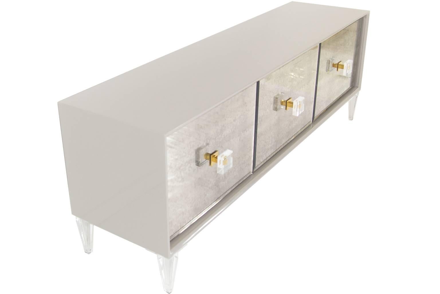 The Juliette Credenza with Modshop's classic matte white or Greystone finish and gorgeous antique mirrors is sure to stun. The 3 door credenza sits on top of our 7