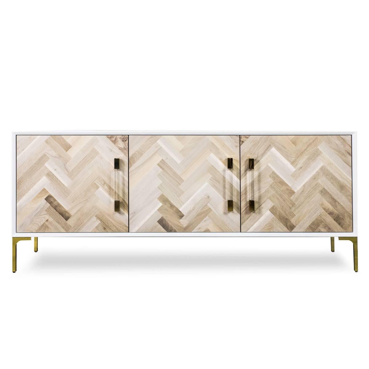 The Amalfi 3 door credenza is perfect for any spaces, with North American Bleached or South American Oiled Walnut finished doors. Surrounded by a matte white finish, the wood pieces placed on the doors create a large herringbone effect. The doors