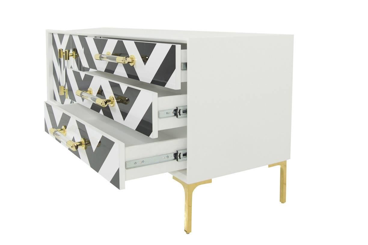 The Italian island of Capri inspired the textures and colors that would make up our Capri Credenza. It incorporates the ever-present Chevron trend in the beautifully crafted door fronts. The doors are finished off with a lucite and brass bar pulls.