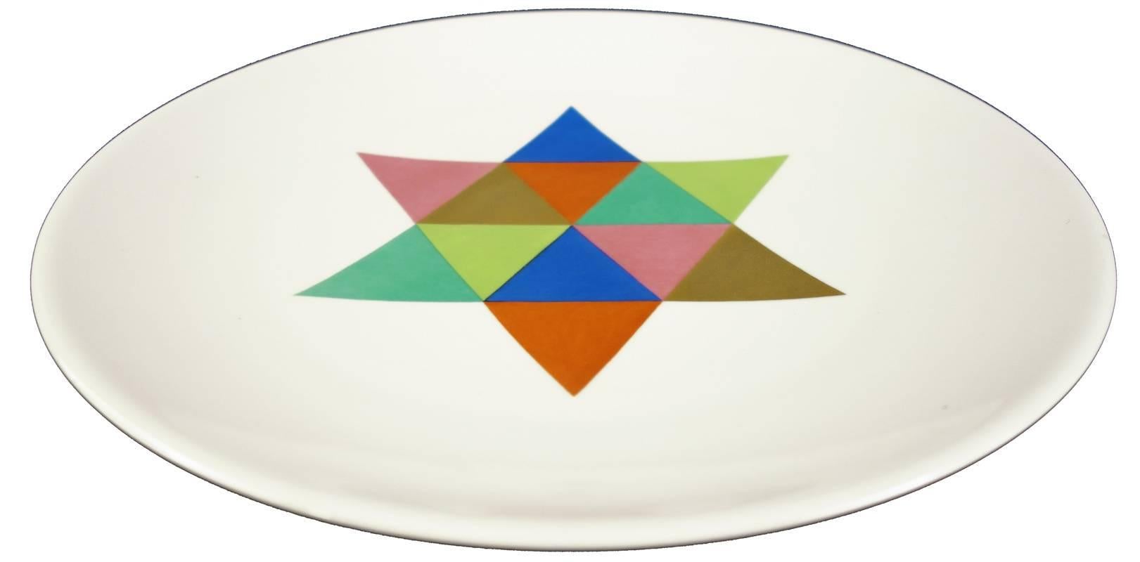 Alexander Girard created these plates for the Miller House, one of the most iconic examples of Mid-Century designs. These are original with very little use and in amazing condition. Glazed porcelain with applied decoration. The gold color is