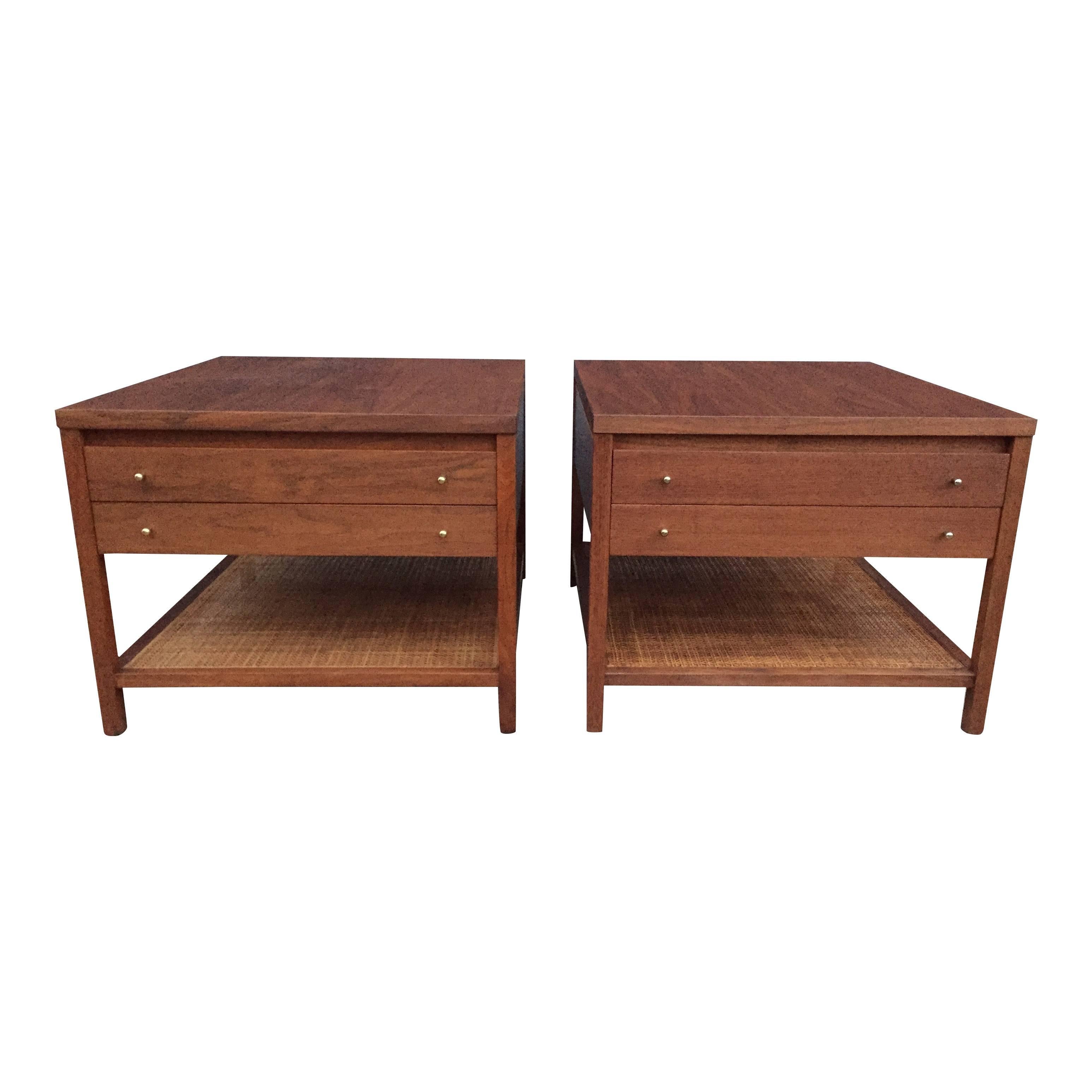 A pair of Paul McCobb side tables for Calvin Group having rattan lower shelves, two drawers and brass pulls. Excellent as end tables, side tables or bedside tables. Expertly restored and refinished.