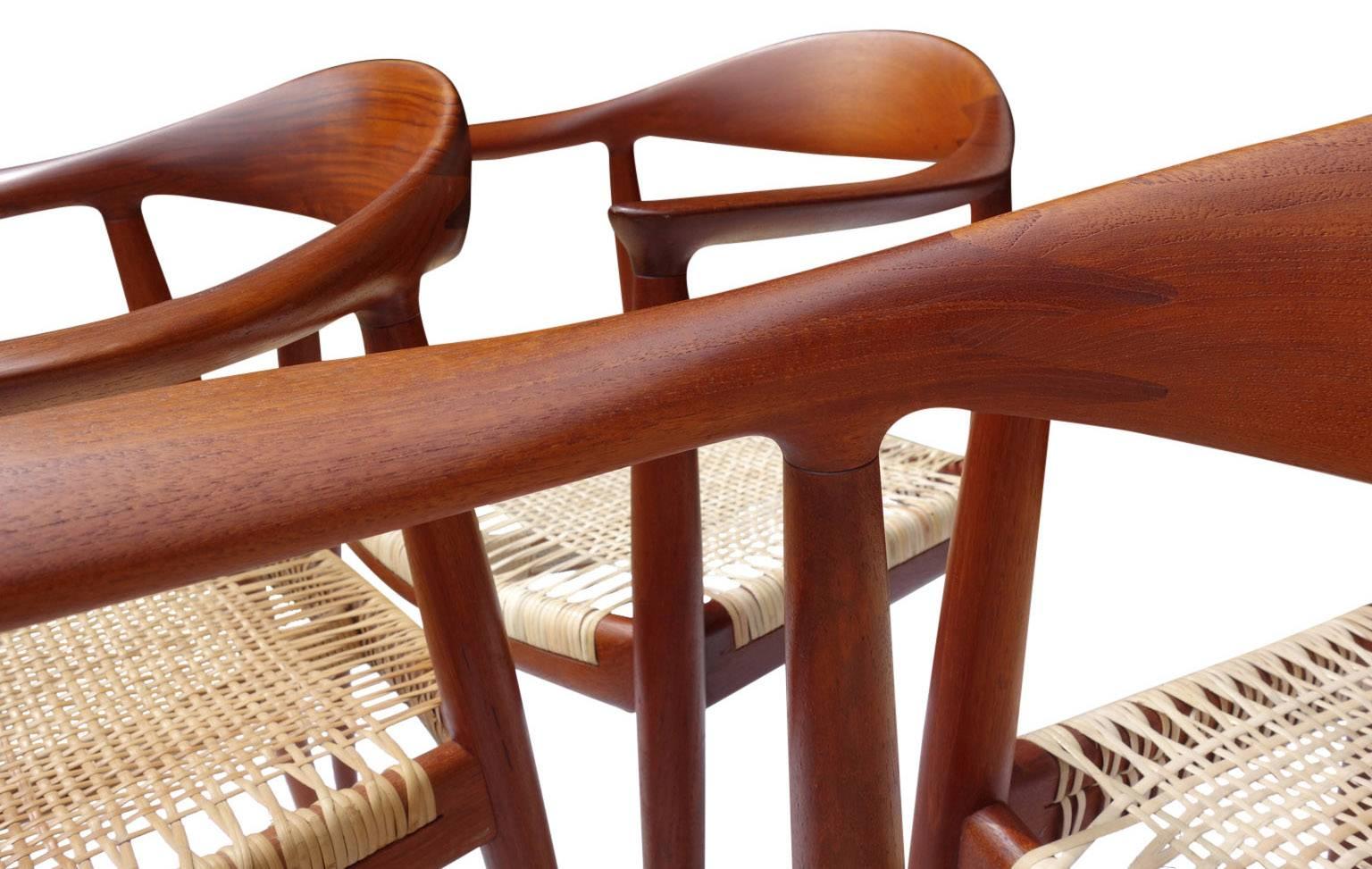 Model JH501 Denmark, 1960s; Teak, woven reed; Branded with designer and manufacturer name (Johannes Hansen) with distributor's paper Knoll label. Three chairs have been re-caned. All Cane is in excellent condition. Also known as "The