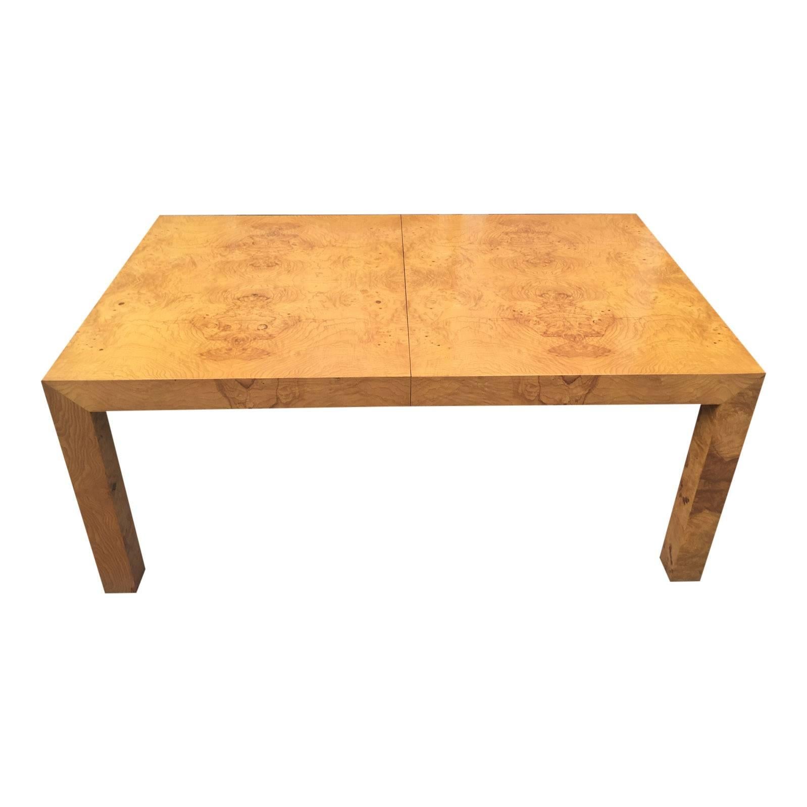 A perfectly-proportioned Parsons table by Milo Baughman, with two extension leaves. Highly figured burled olivewood. A great piece to give some pop to any room.

The table is in very nice vintage condition.

Dimensions: 28'' high, 39'' deep,